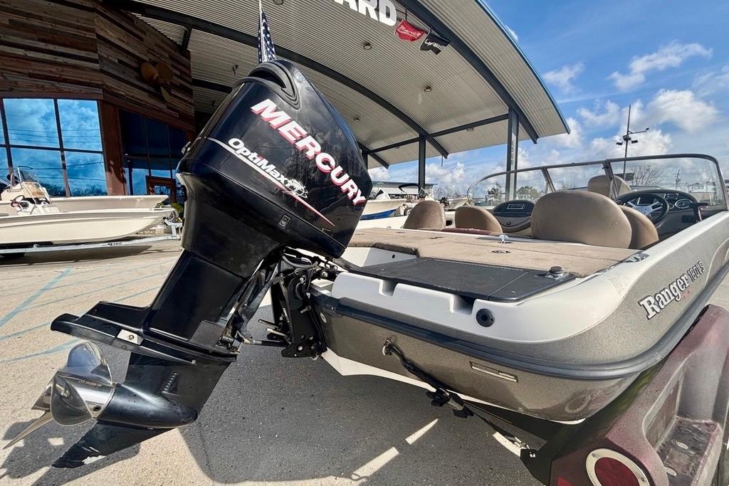 2008 Ranger 180 Reata boat with Mercury OptiMax engine, parked outdoors.