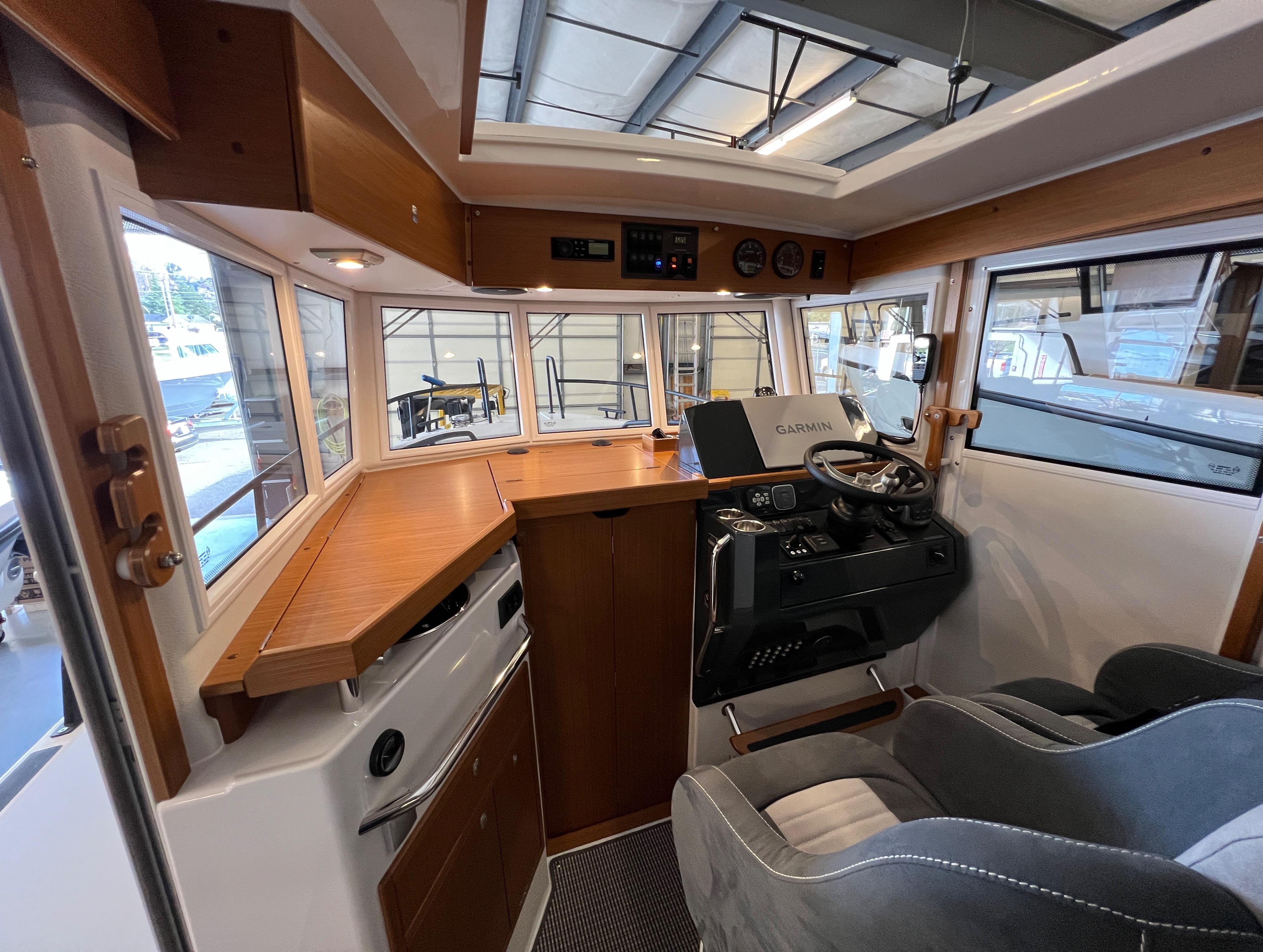 Interior of 2024 Sargo 28 boat with modern helm and wooden accents.