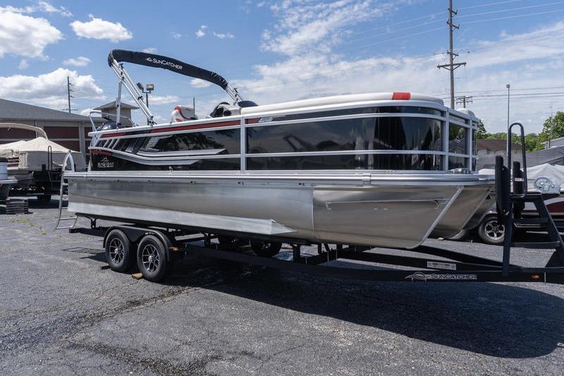 2026 SunCatcher Select 322SL pontoon boat on trailer under clear sky.
