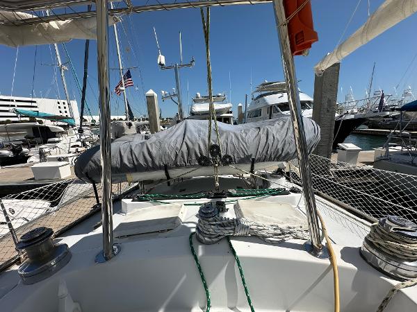Alt text: 1989 Concordia 52 sailboat docked at marina with covered mainsail.