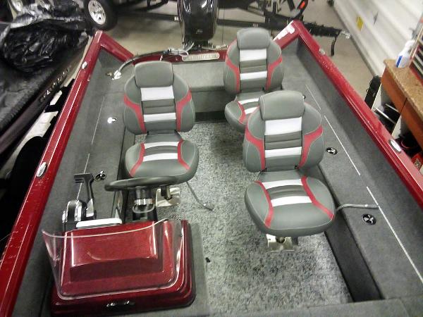 2025 Ranger VS1665 SC boat interior with four gray and red seats, steering console, and carpeted floor.