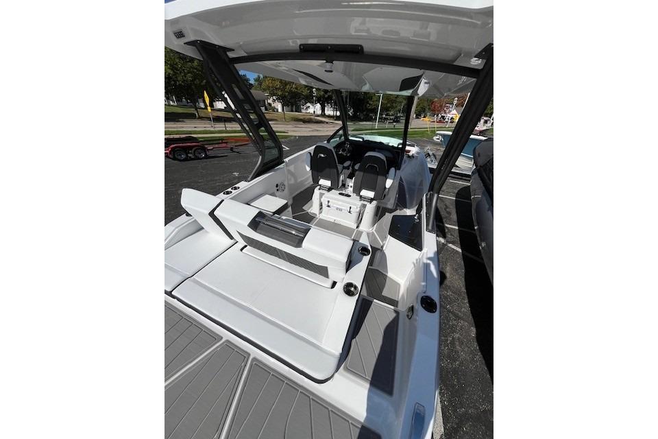 2026 Monterey Elite 27 SD boat interior with seating and helm, parked outdoors.