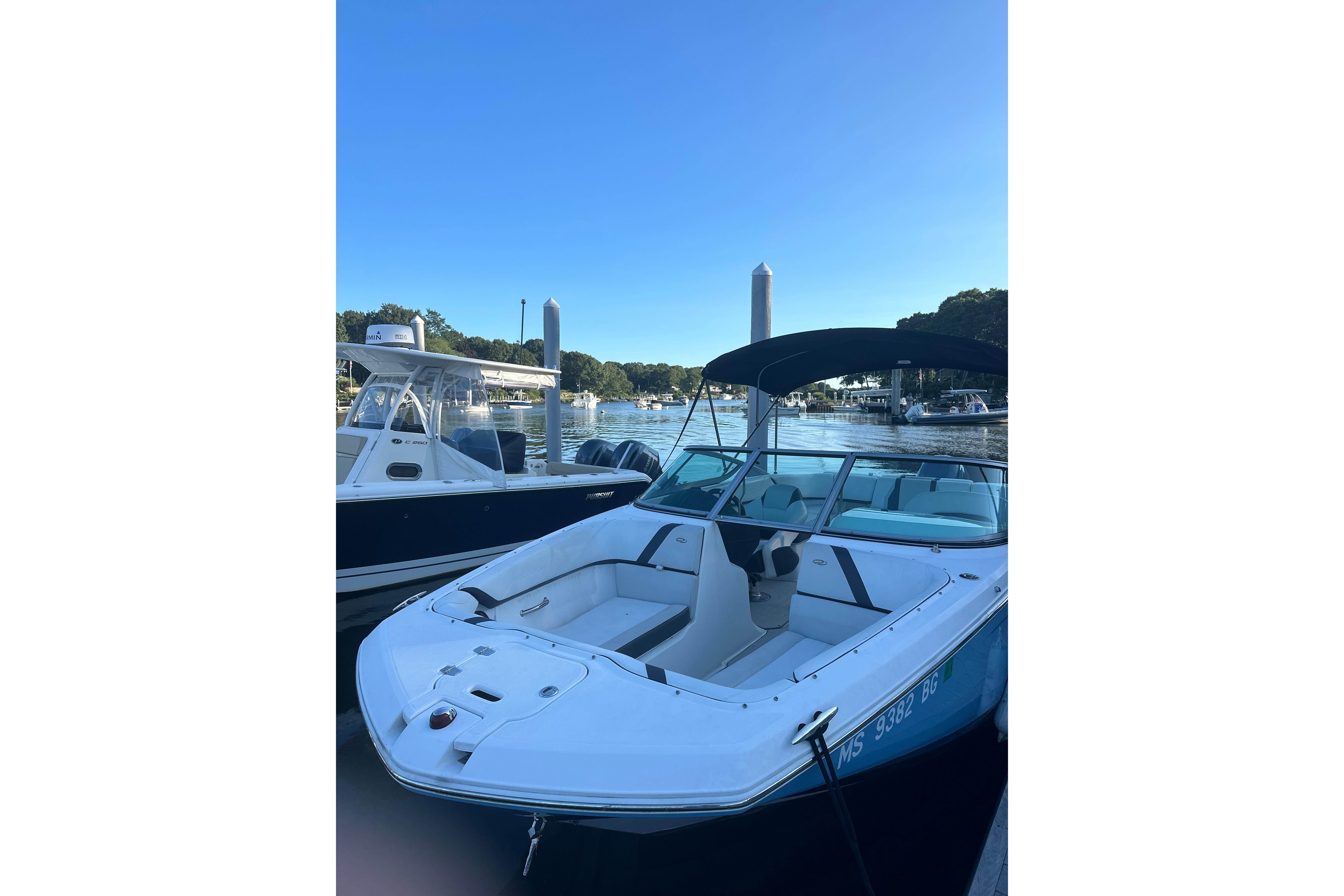 2017 Regal 23 OBX boat docked at marina under clear blue sky.