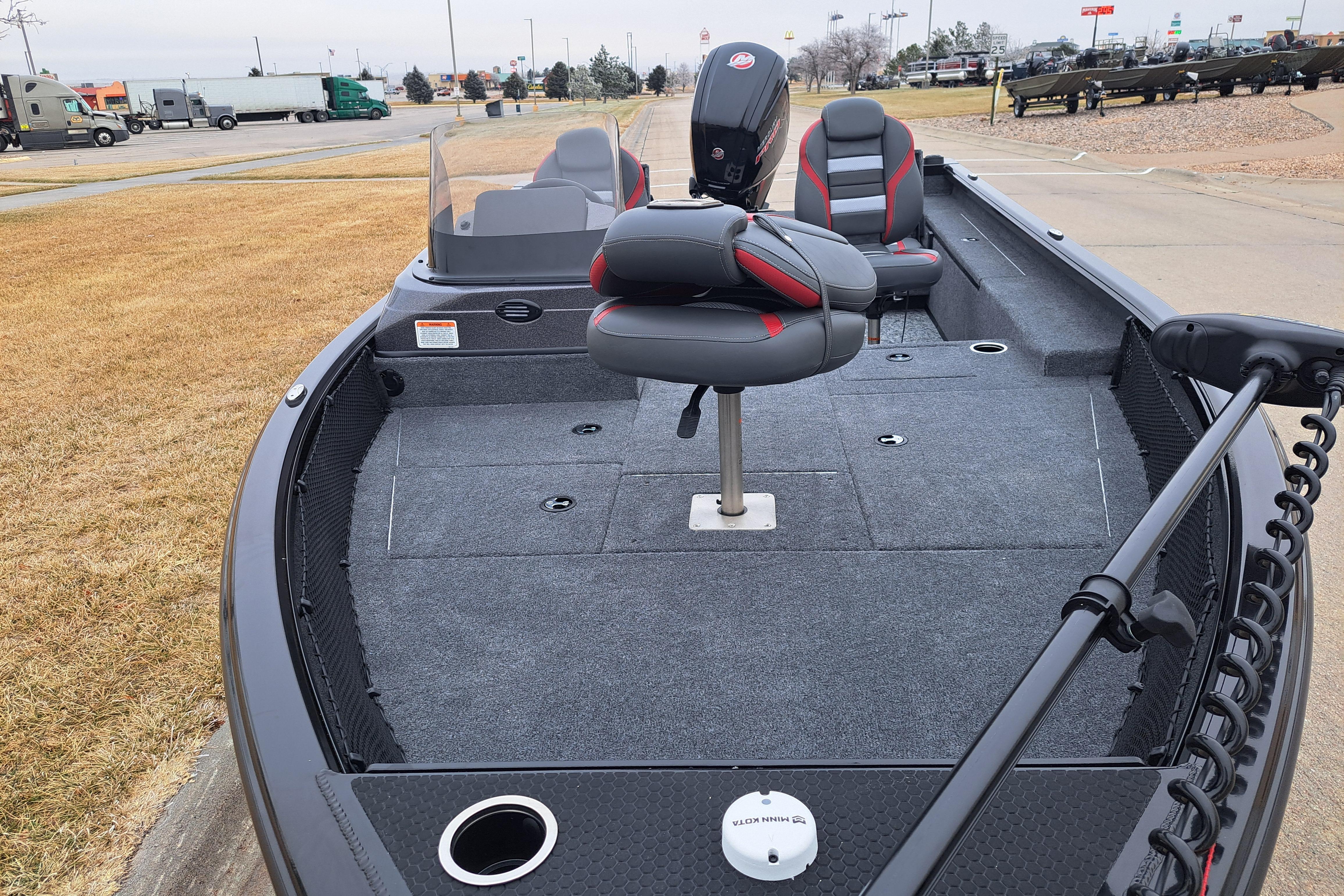 2026 Ranger VS1782SC Reata fishing boat with seating and trolling motor, parked outdoors.