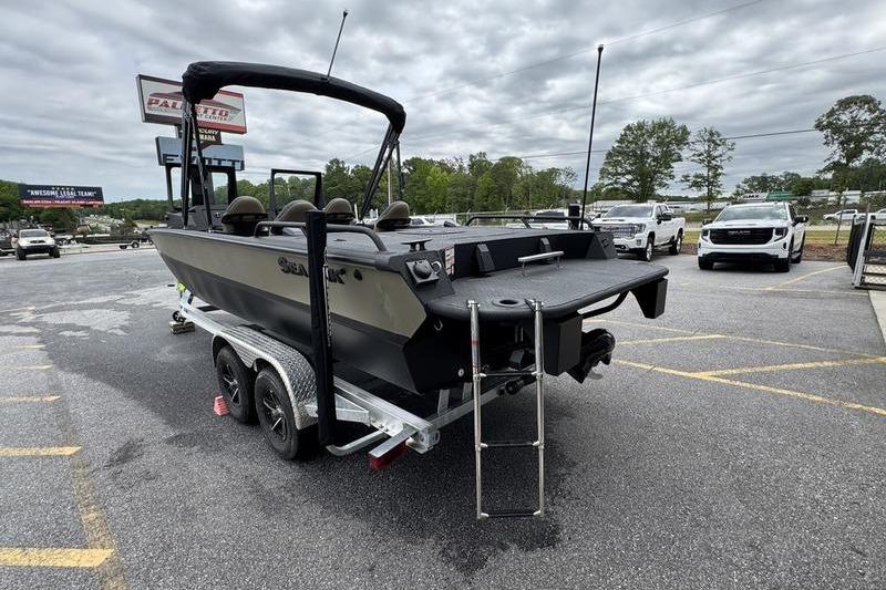 2026 SeaArk Predator 300 AK boat on trailer in parking lot, overcast sky.