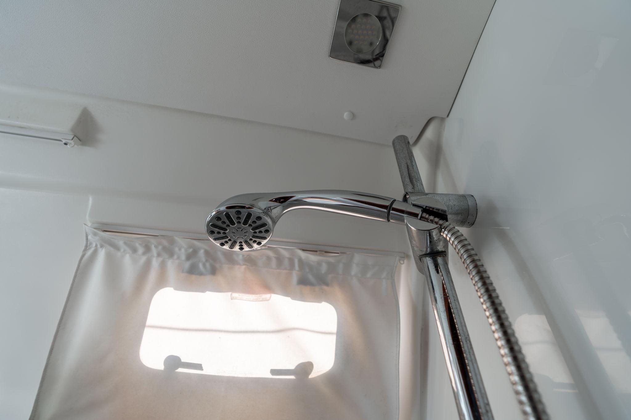 Shower area in 2013 Beneteau Oceanis 50 yacht, featuring chrome fixtures and a window.