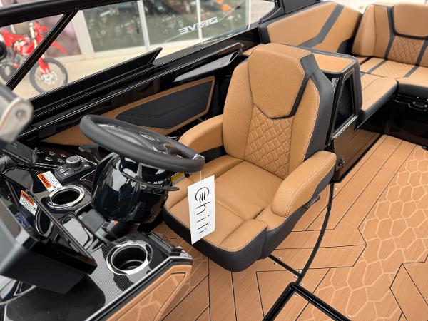 2025 Yamaha Boats 255XD interior with tan seating and modern dashboard design.