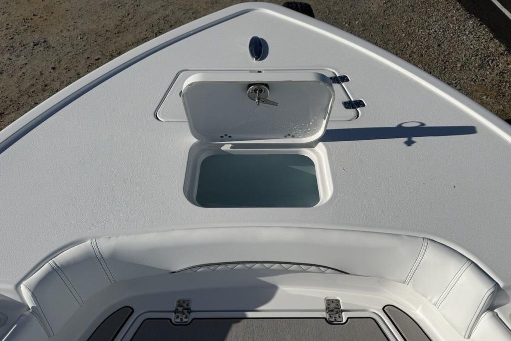 2026 Sportsman Masters 247OE Bay Boat deck with open storage compartment.