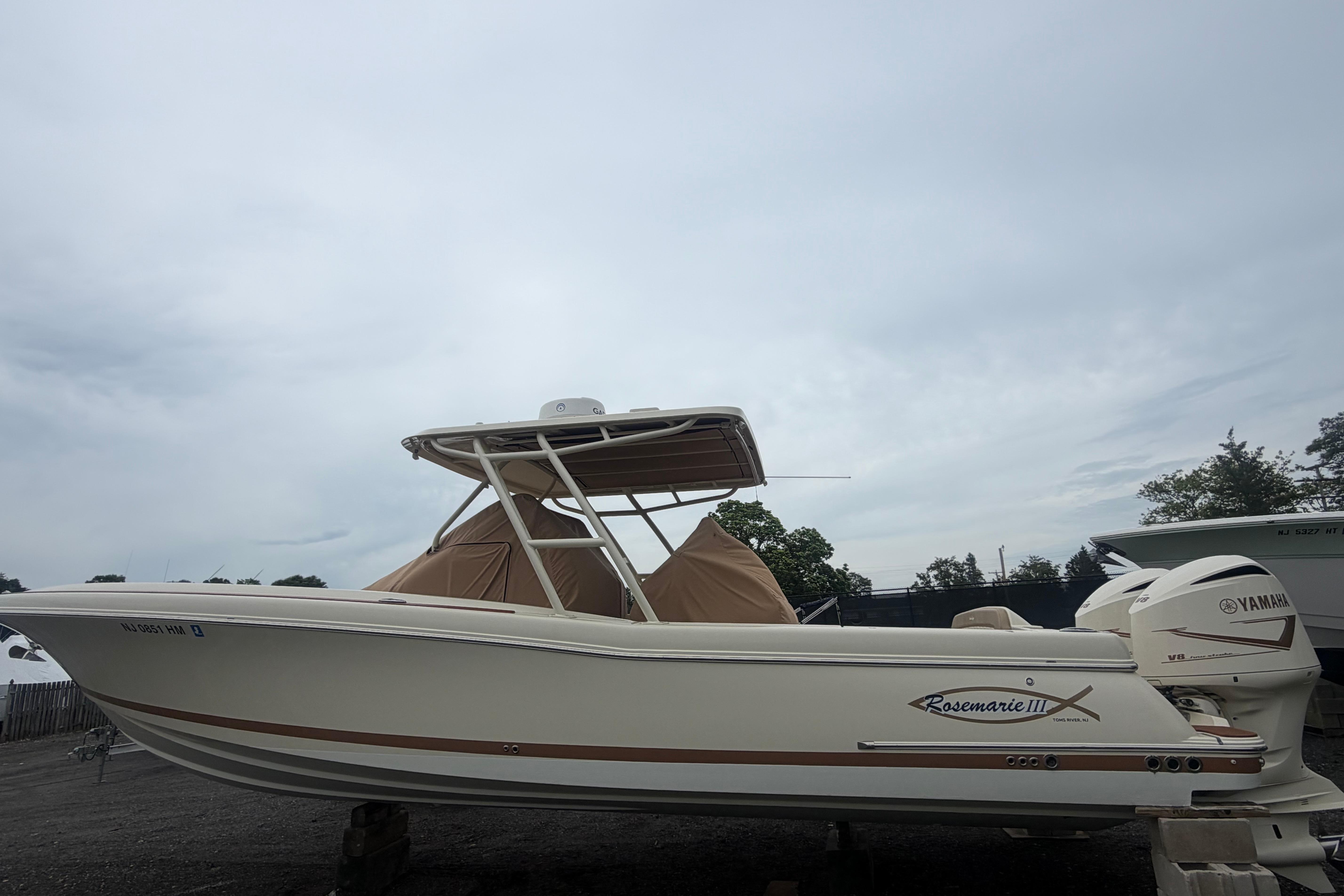 2017 Chris-Craft Catalina 34 boat with Yamaha engines, parked outdoors under cloudy skies.