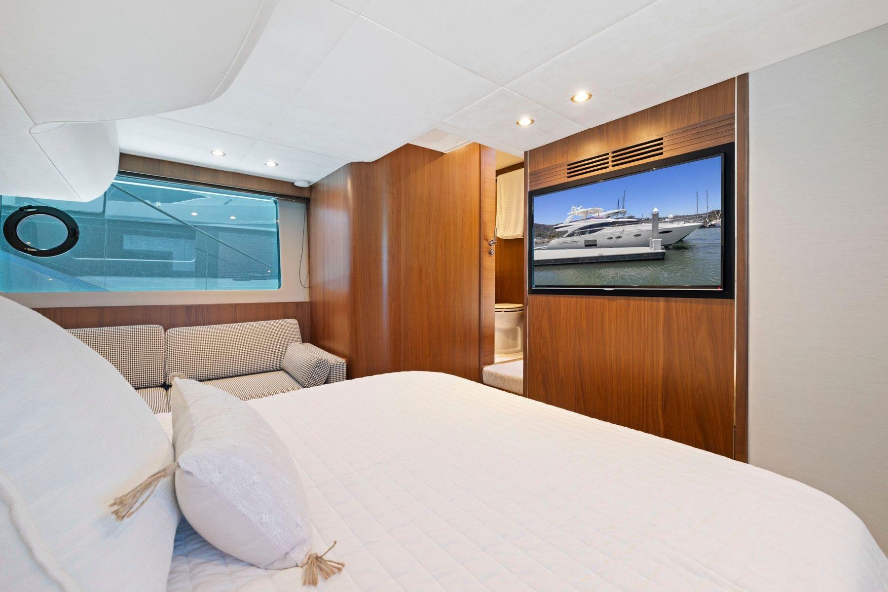 Luxurious bedroom interior of 2015 Princess 60 Flybridge Motor Yacht with modern amenities.