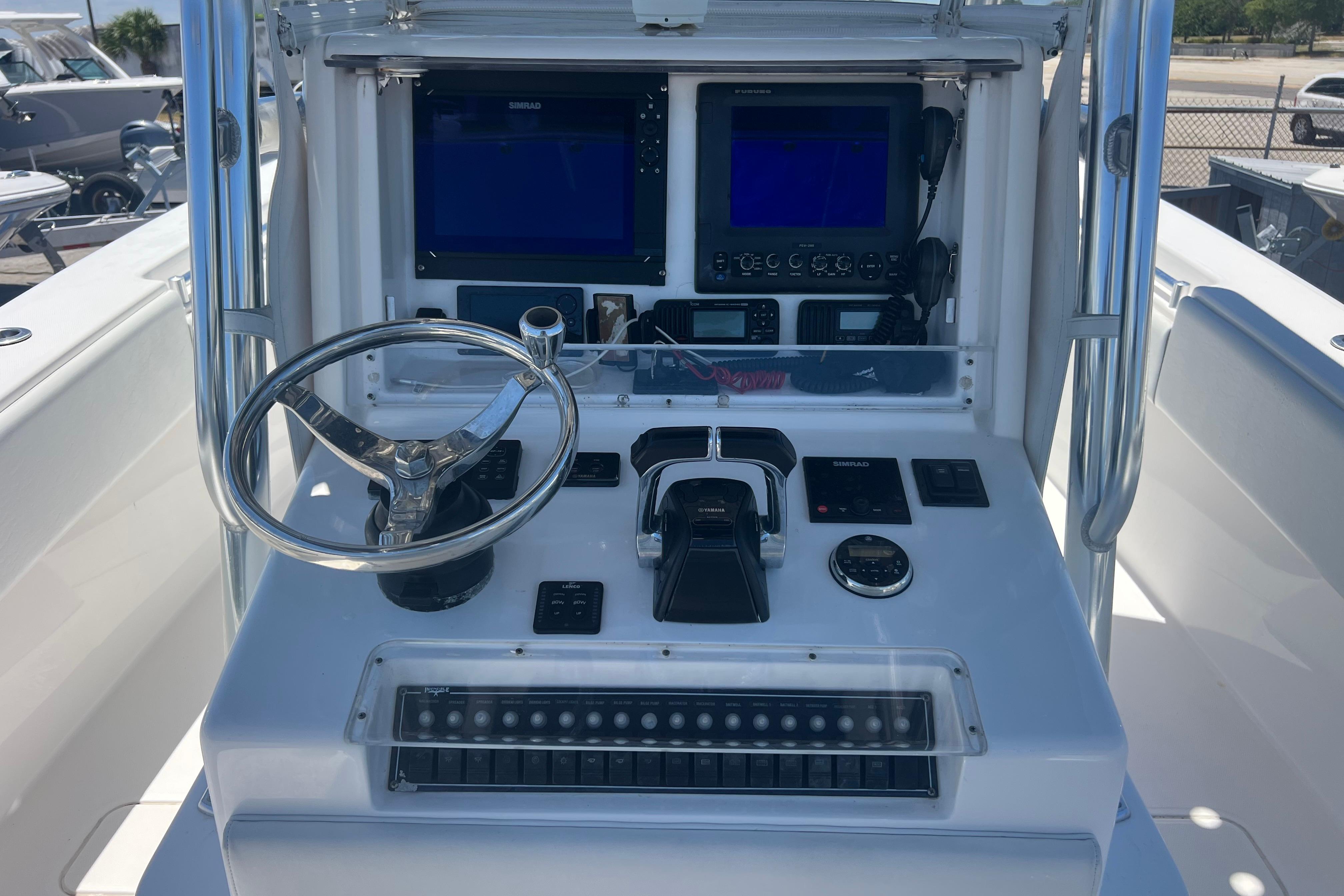 2012 Invincible 33 Open Fisherman boat console with steering wheel and navigation equipment.