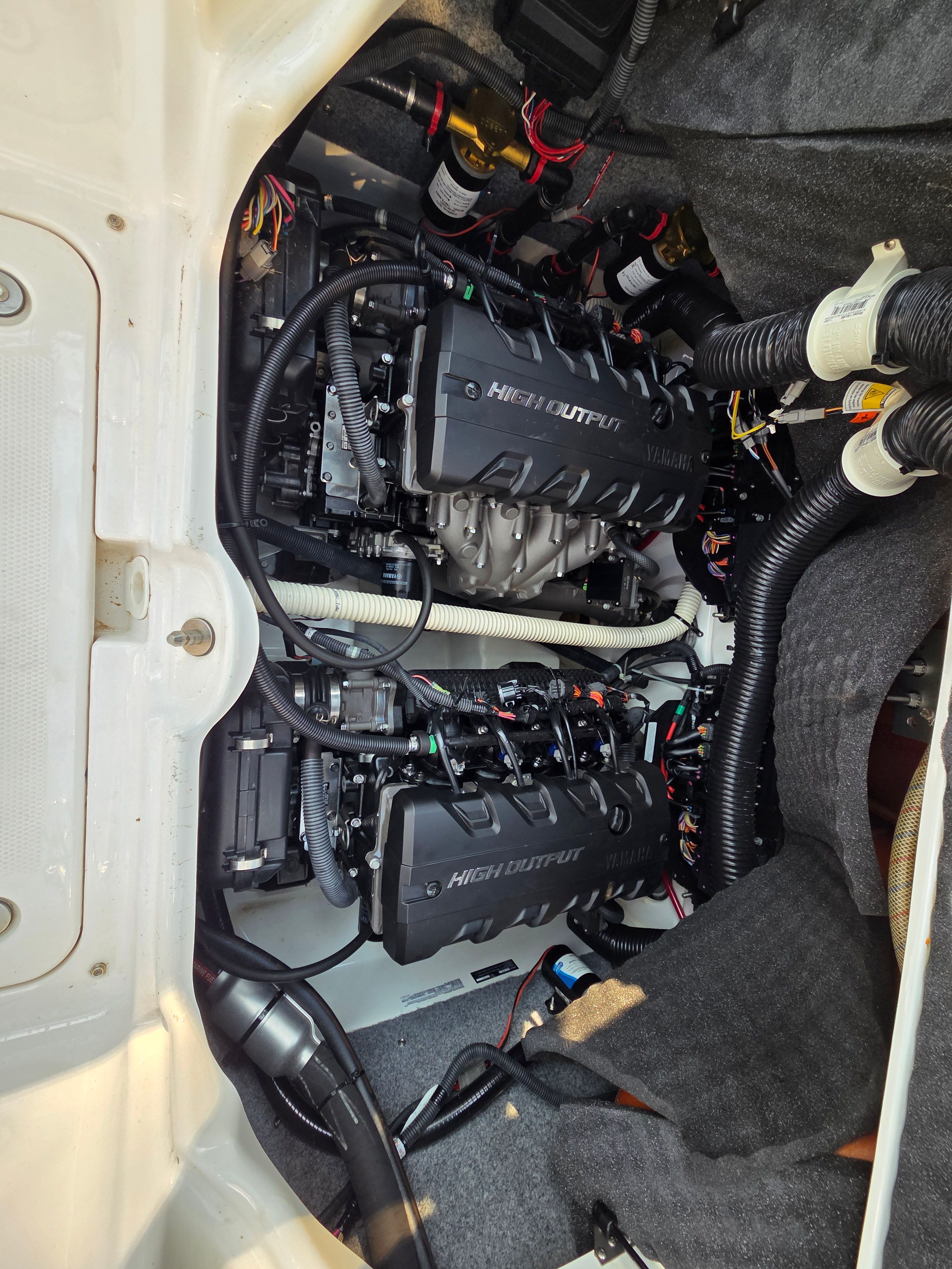 The engine compartment of a 2016 Yamaha 242X E-Series boat with two high-output engines.