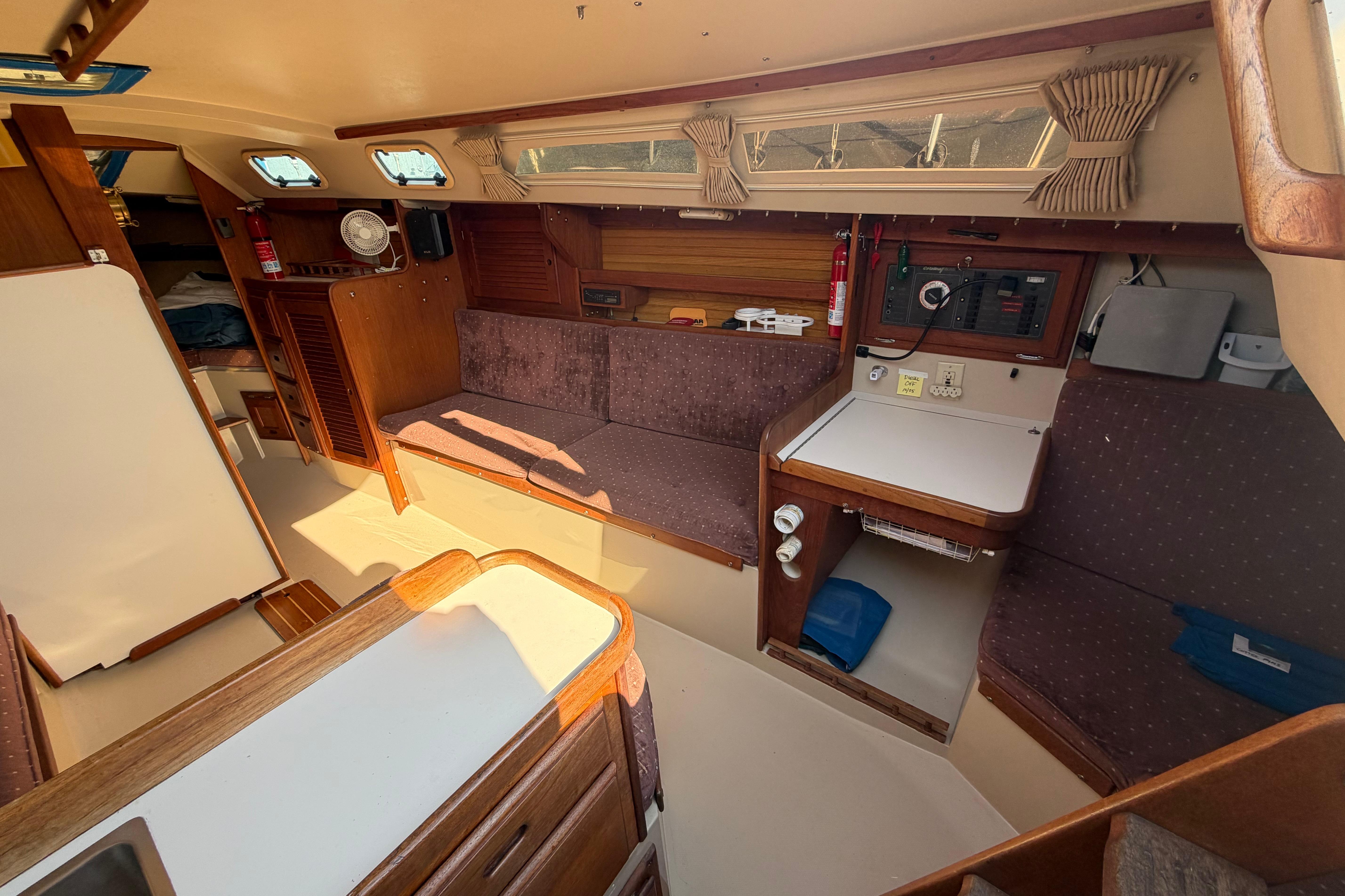 Interior of a 1988 Catalina 30 MkII sailboat, featuring cozy seating and navigation area.