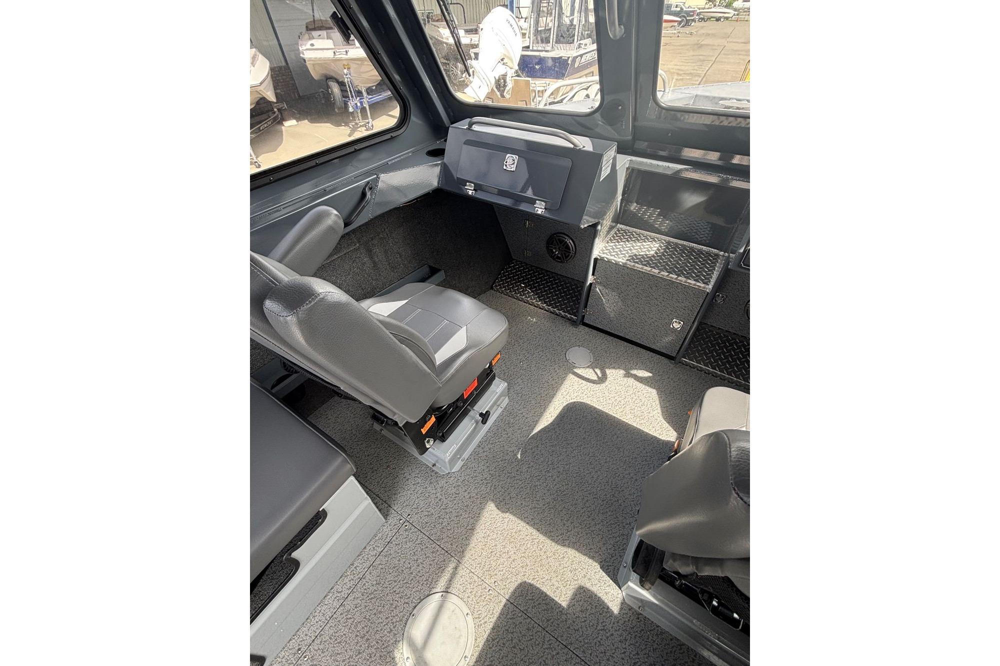 Interior of 2024 Hewescraft 240 Ocean Pro Hardtop, featuring helm and seating area.