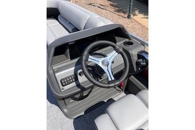 2026 Sun Tracker SportFish 22 DLX boat dashboard with steering wheel and controls.
