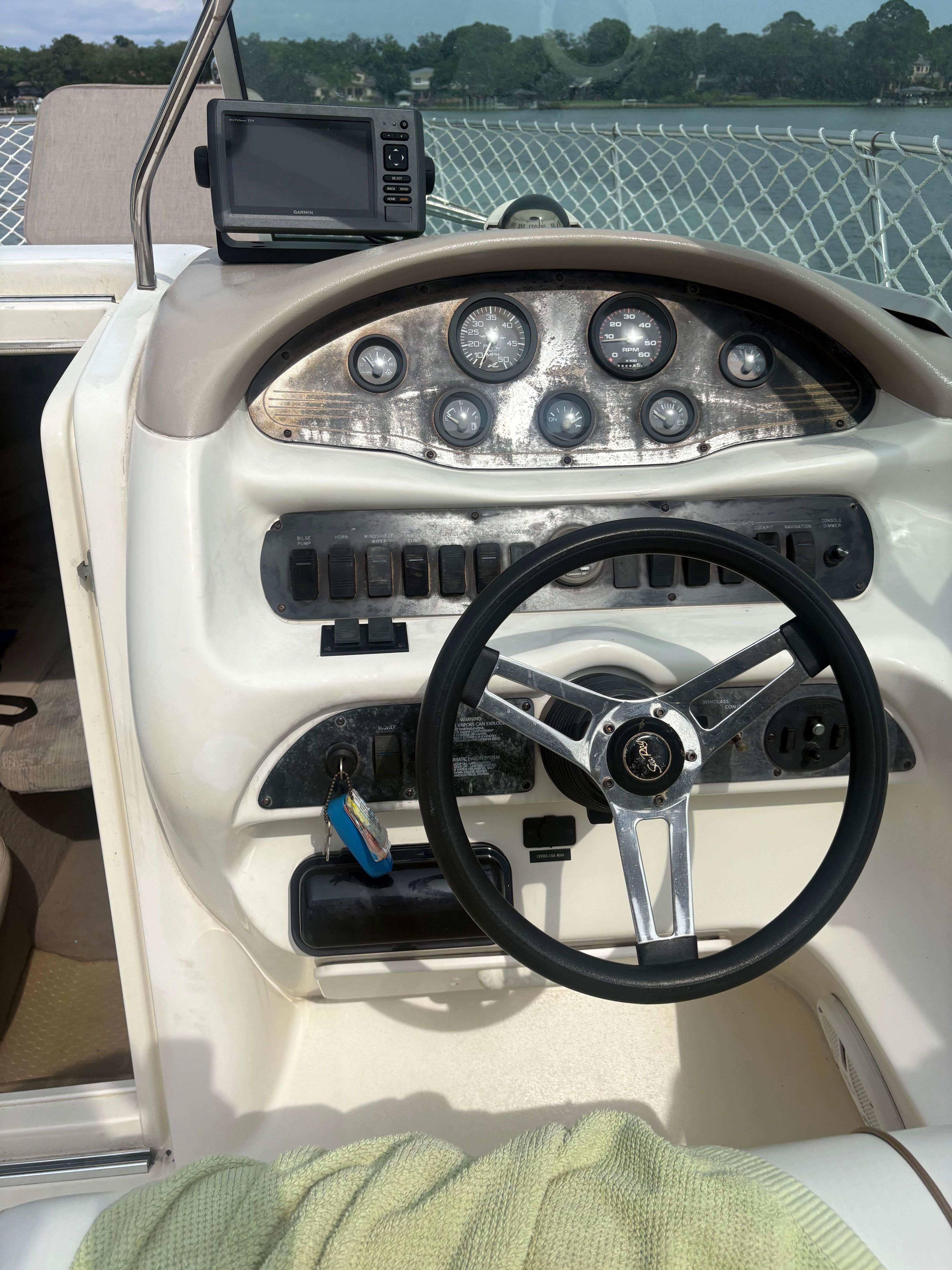 The image shows the helm of a 1996 Sea Ray 280 Cuddy Cabin with multiple gauges.