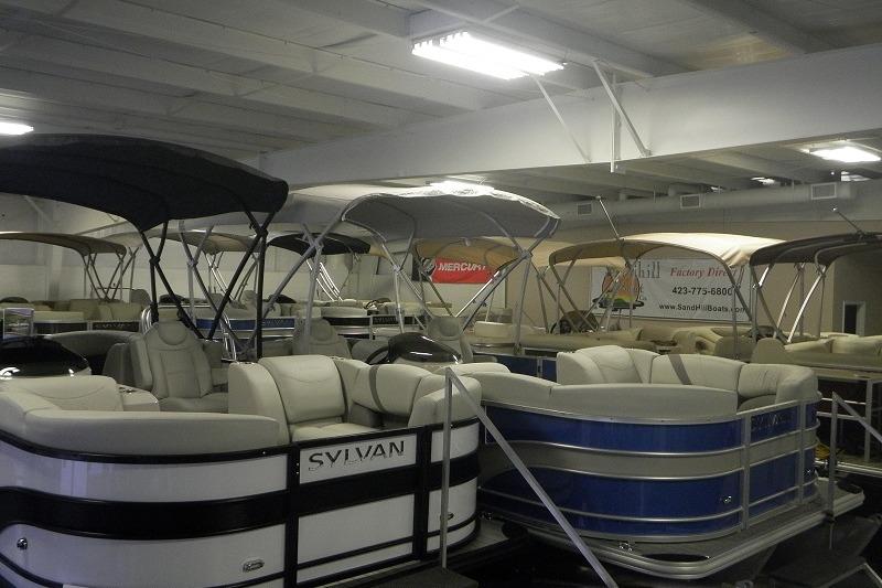2027 Sylvan Mirage 820 CLZ DH pontoon boats displayed in a showroom.