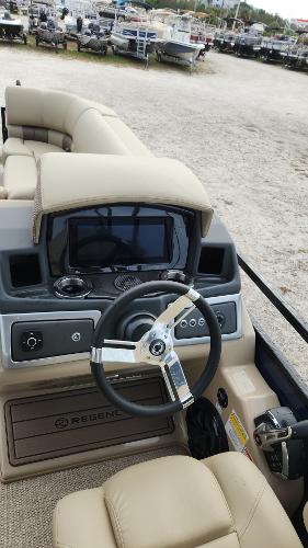 2024 Regency 230 LE3 boat dashboard with steering wheel and control panel.