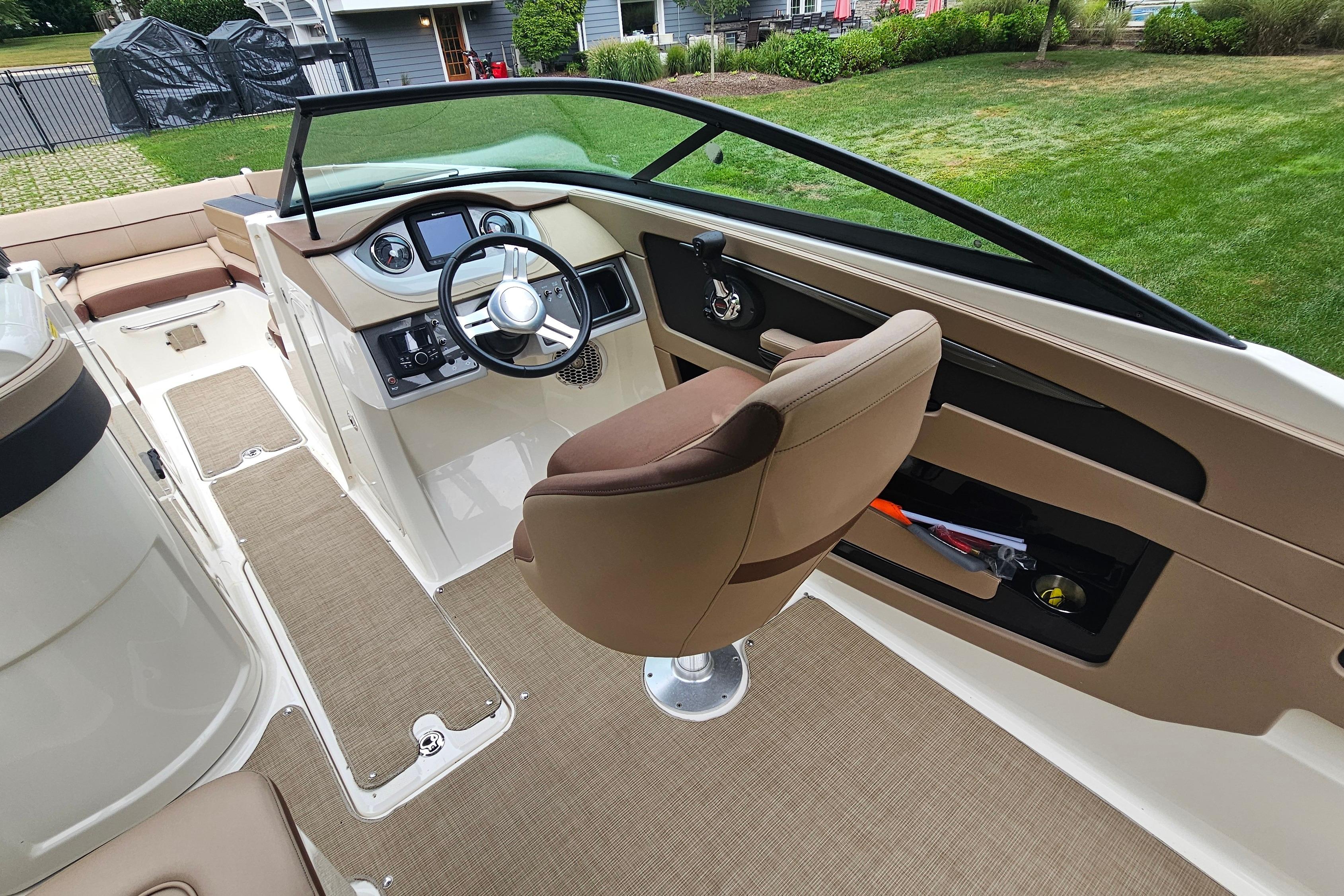 2017 Sea Ray SDX 240 Outboard boat interior with helm, seating, and dashboard.