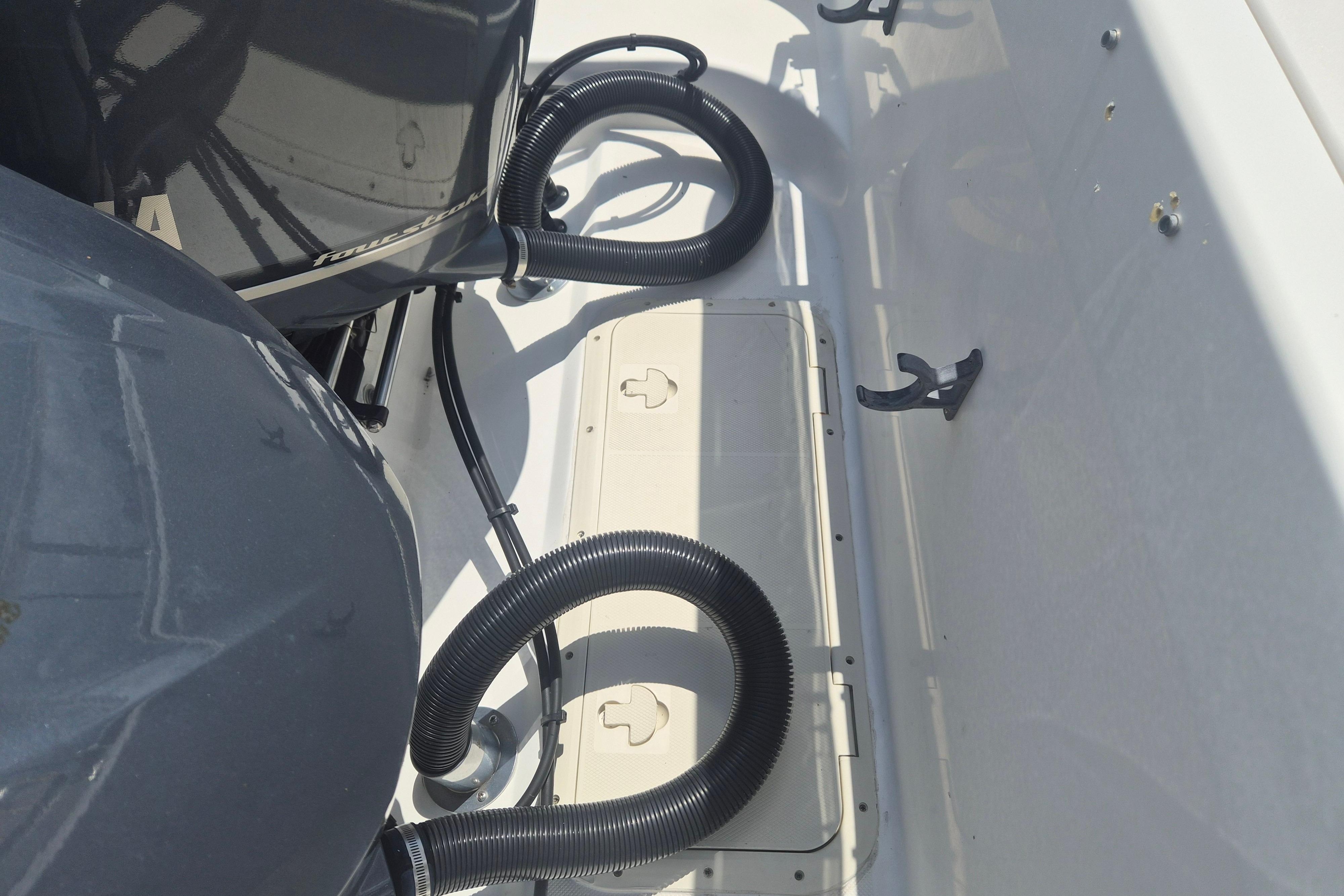 2006 Century 2900 Center Console boat engine compartment with hoses and fittings.