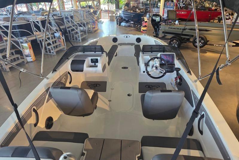 2026 Tahoe T21 boat interior with seating and steering console in showroom.
