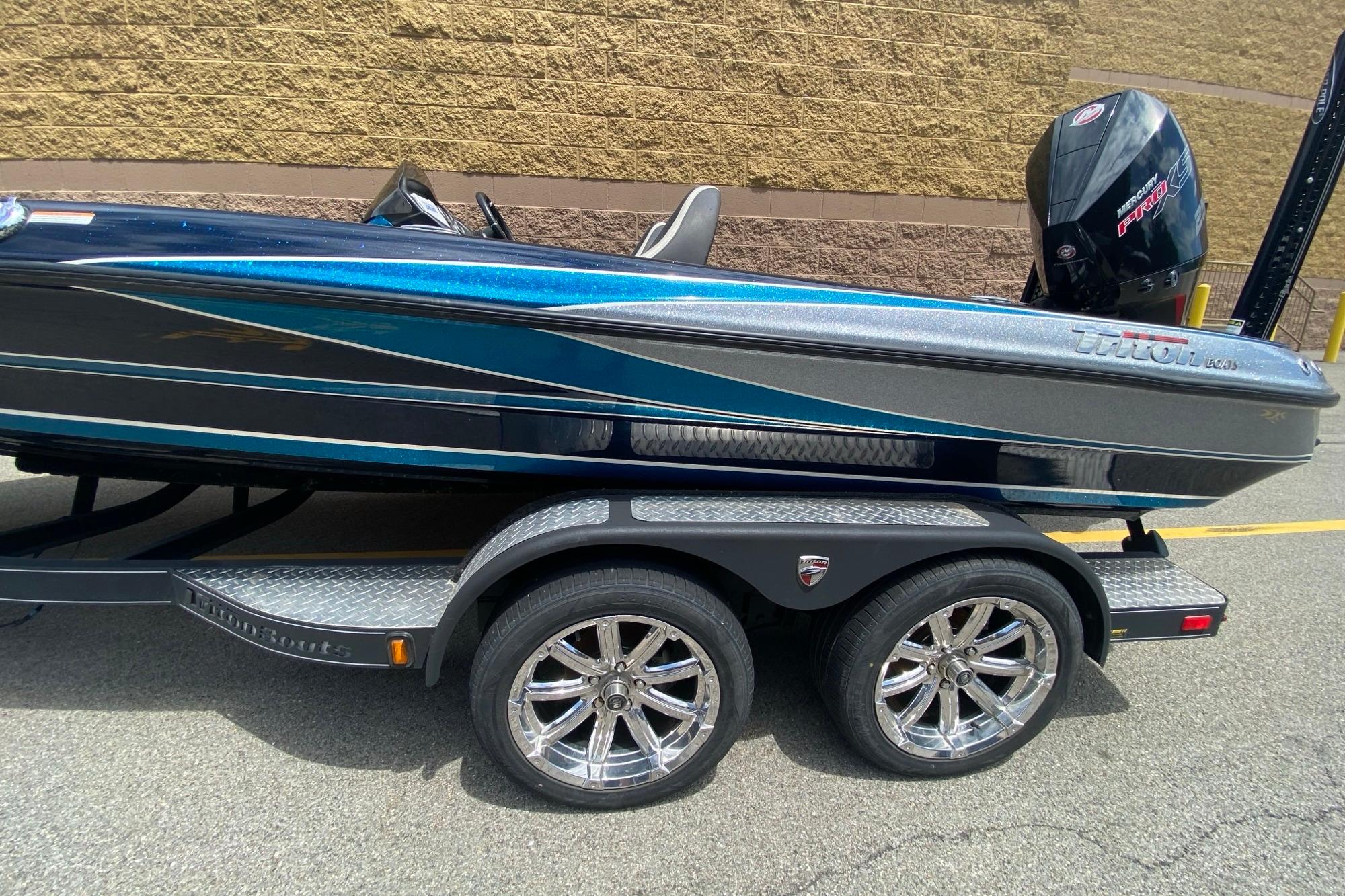 2020 Triton 20 TrX Patriot boat on trailer with chrome wheels.