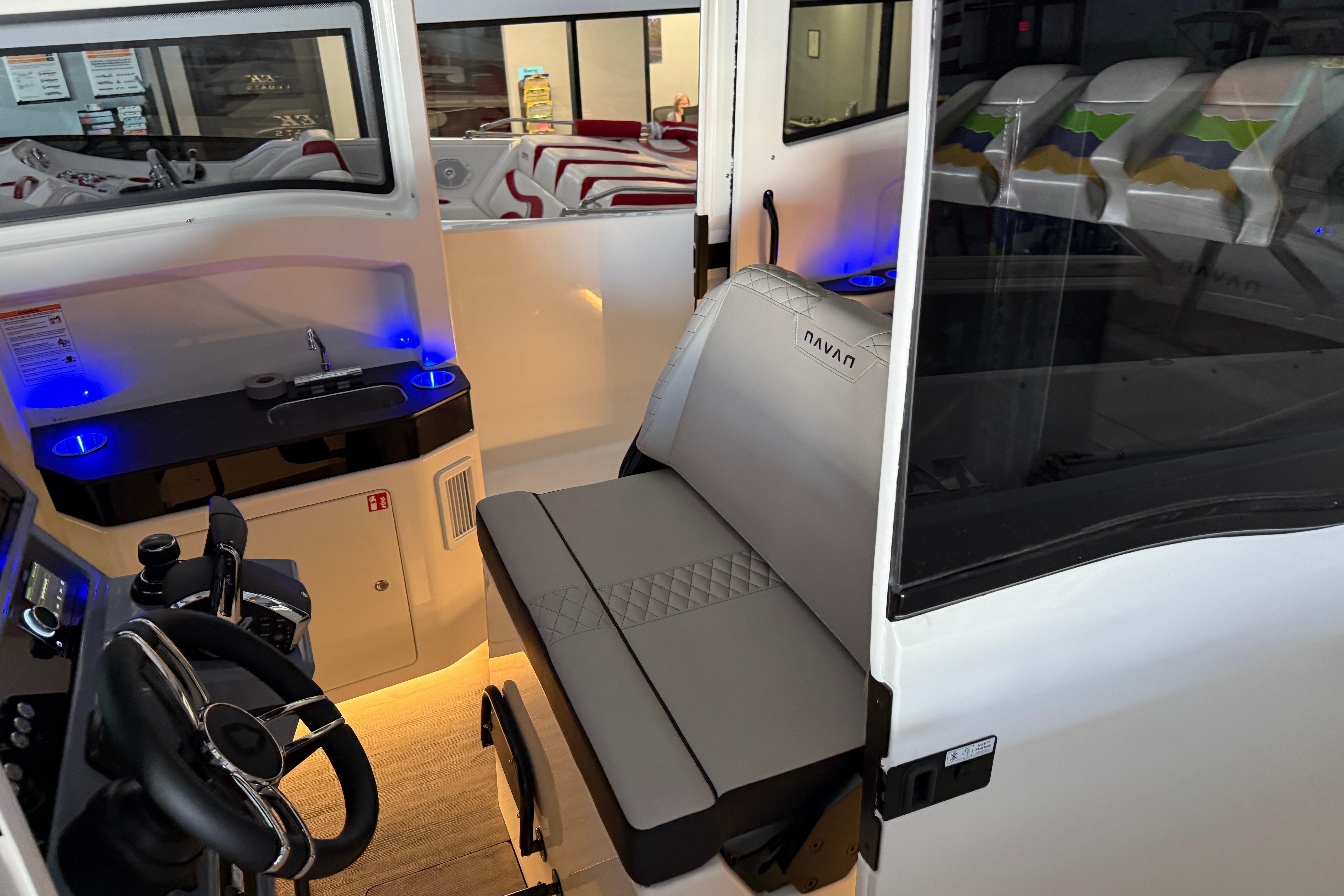 Interior of 2025 Navan C30 boat with modern seating and control panel.