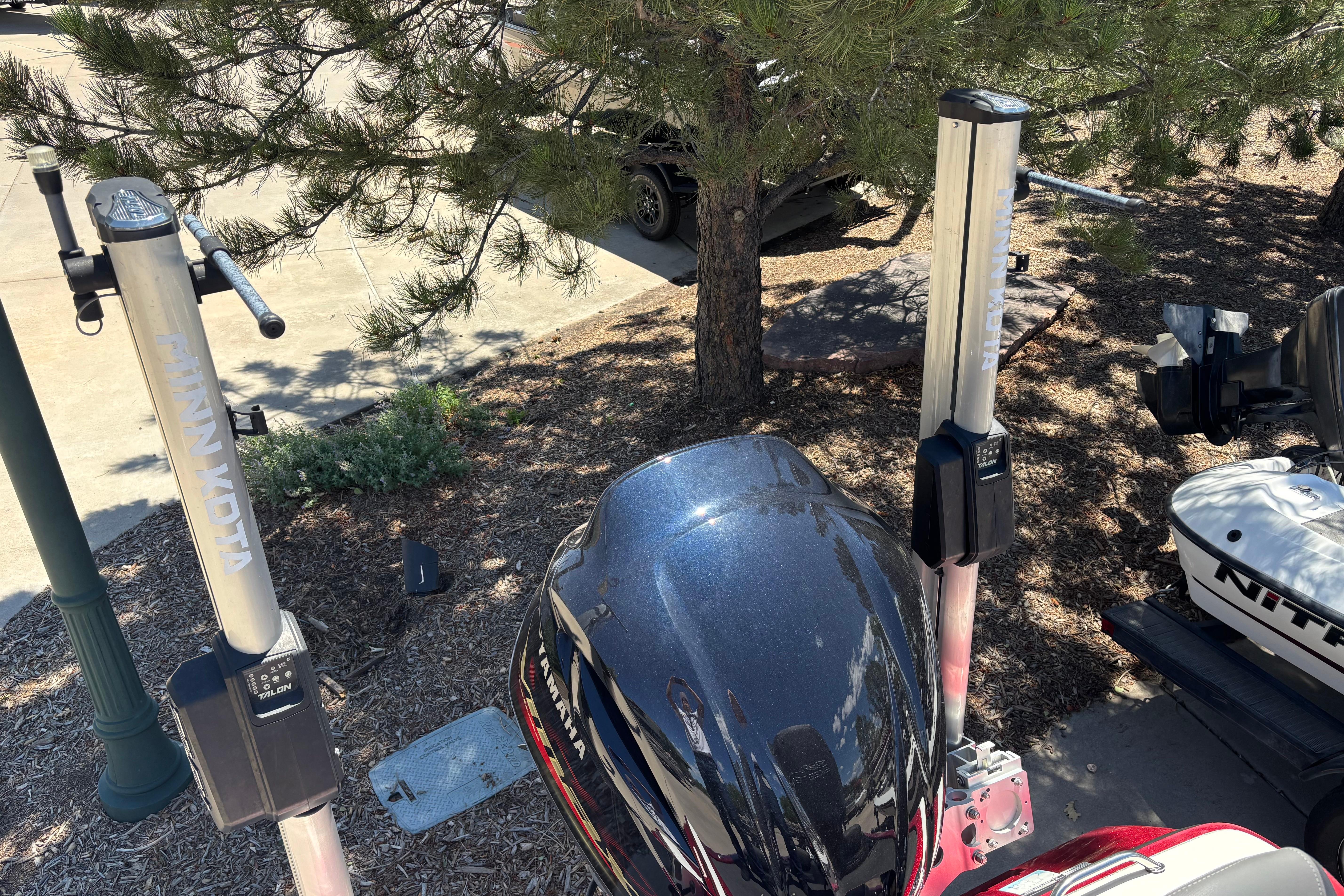 2017 Skeeter FX21 boat with Minn Kota trolling motors in a wooded area.
