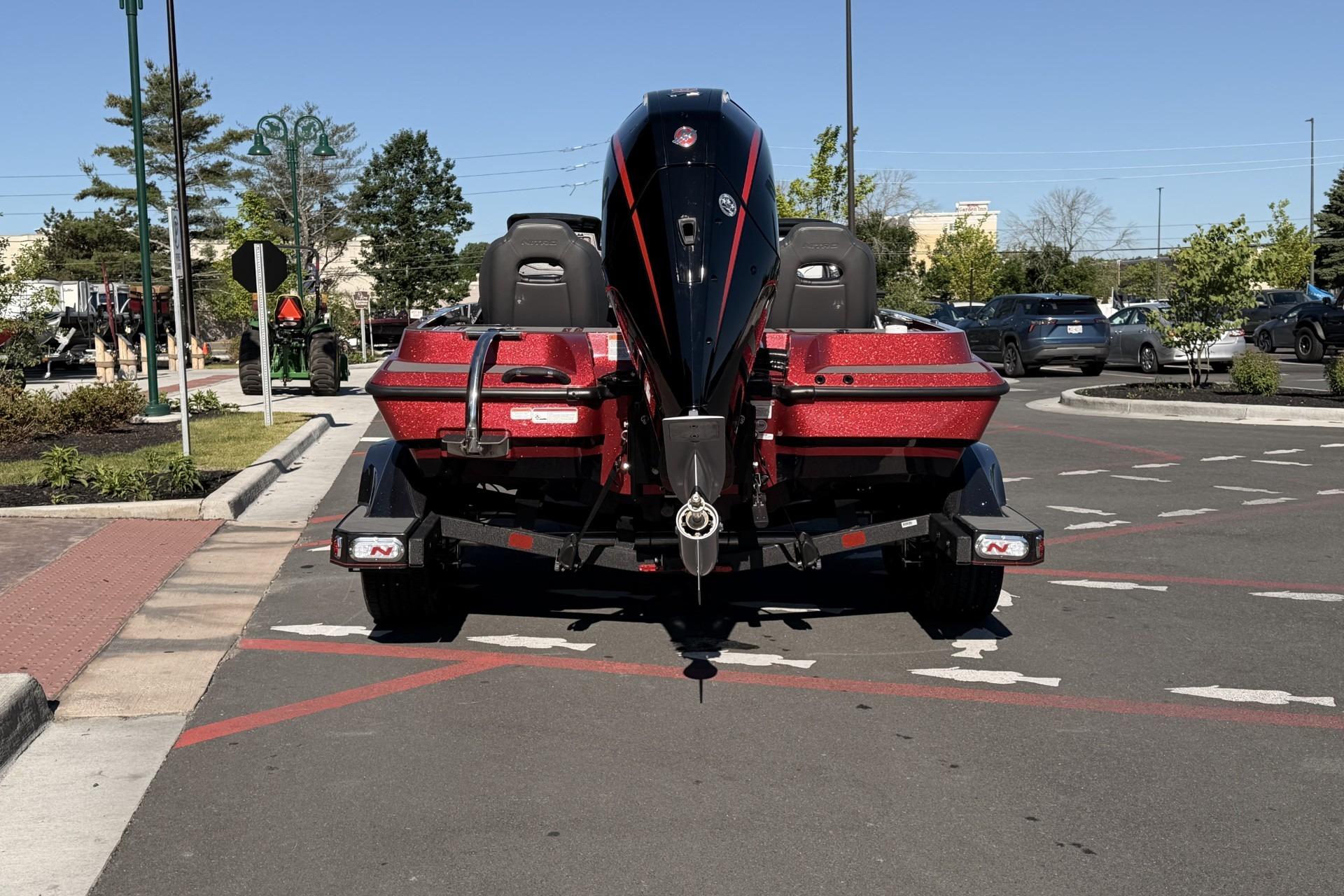 2026 Nitro Z19 XL Pro boat on trailer in parking lot, rear view.