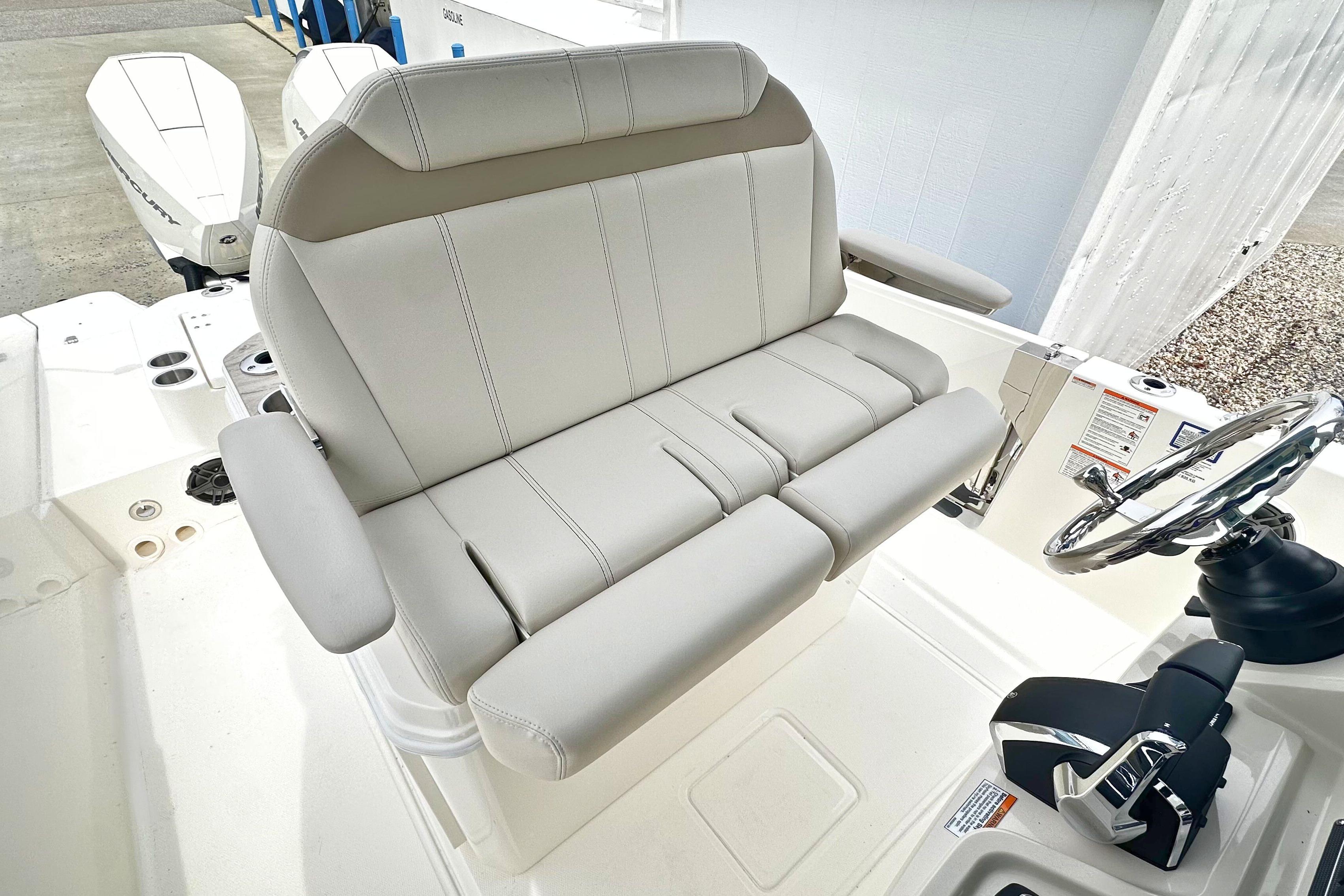 2026 Boston Whaler 280 Dauntless helm seat with armrests and steering wheel.