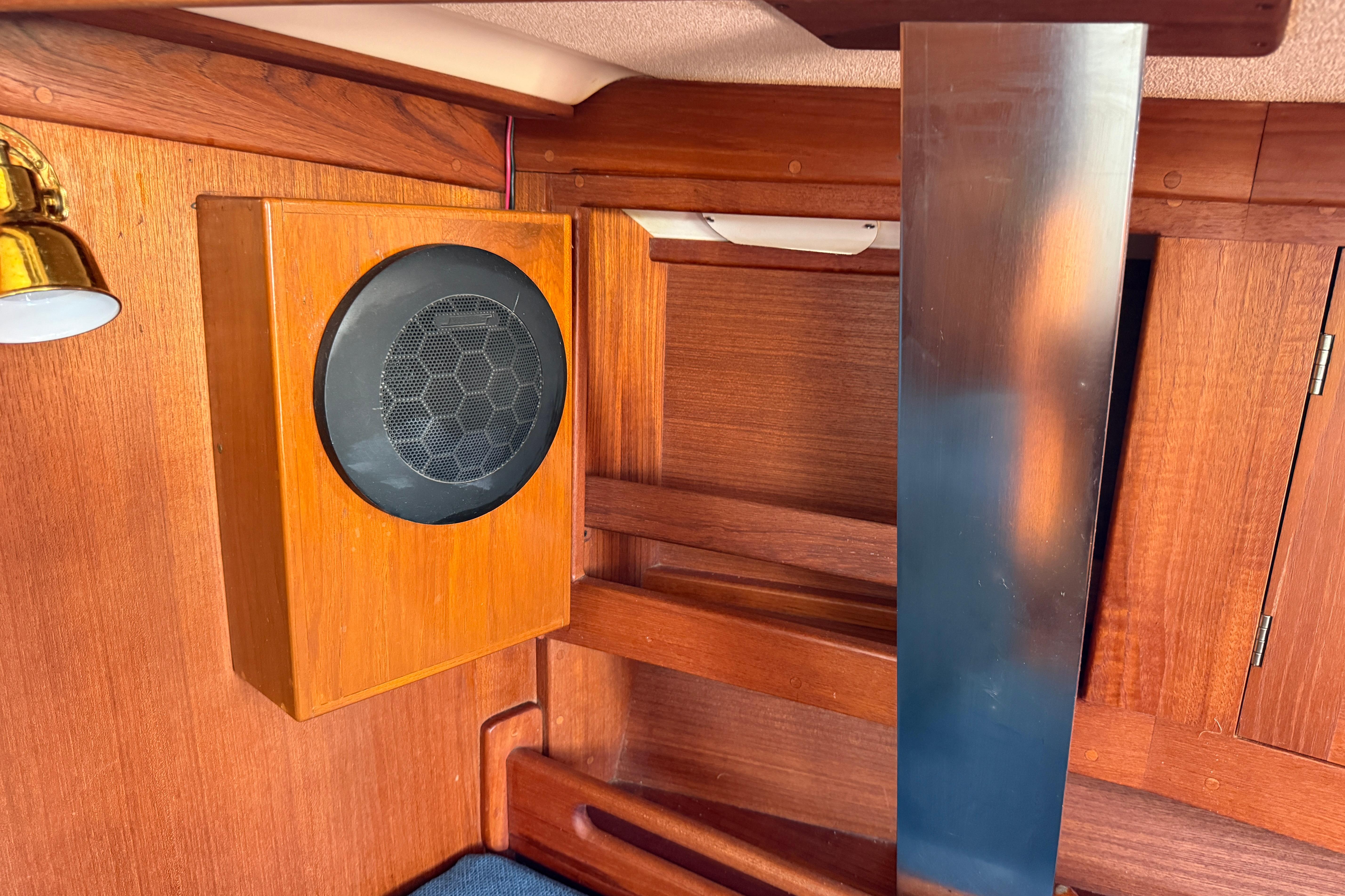 Wooden interior of a 1997 Tartan 3800 sailboat with speaker and metal panel.
