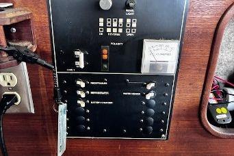 Control panel of a 1985 Bayliner 3270 Motoryacht with switches and gauges.
