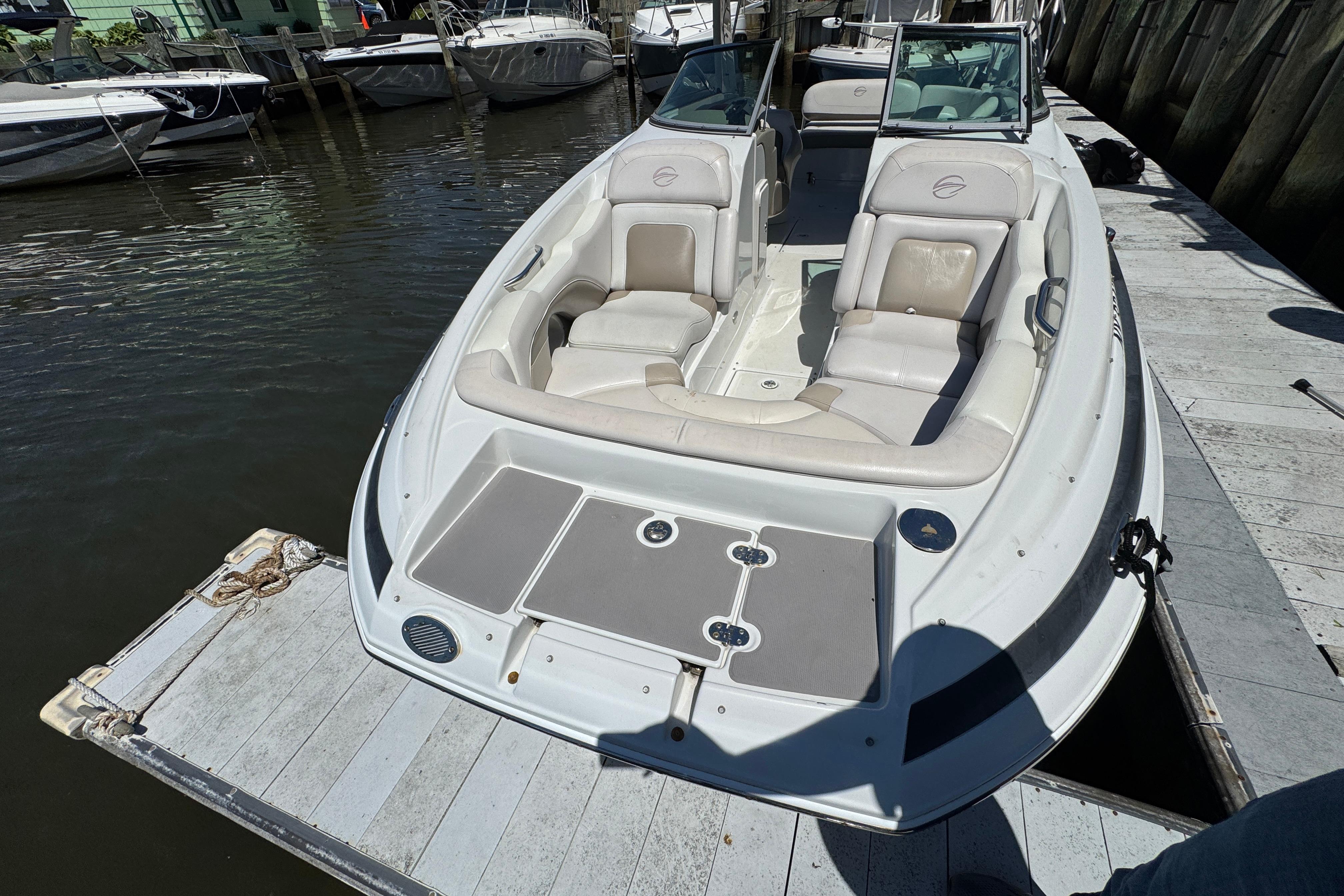 2013 Crownline Eclipse E6 XS boat docked, featuring spacious seating and sleek design.