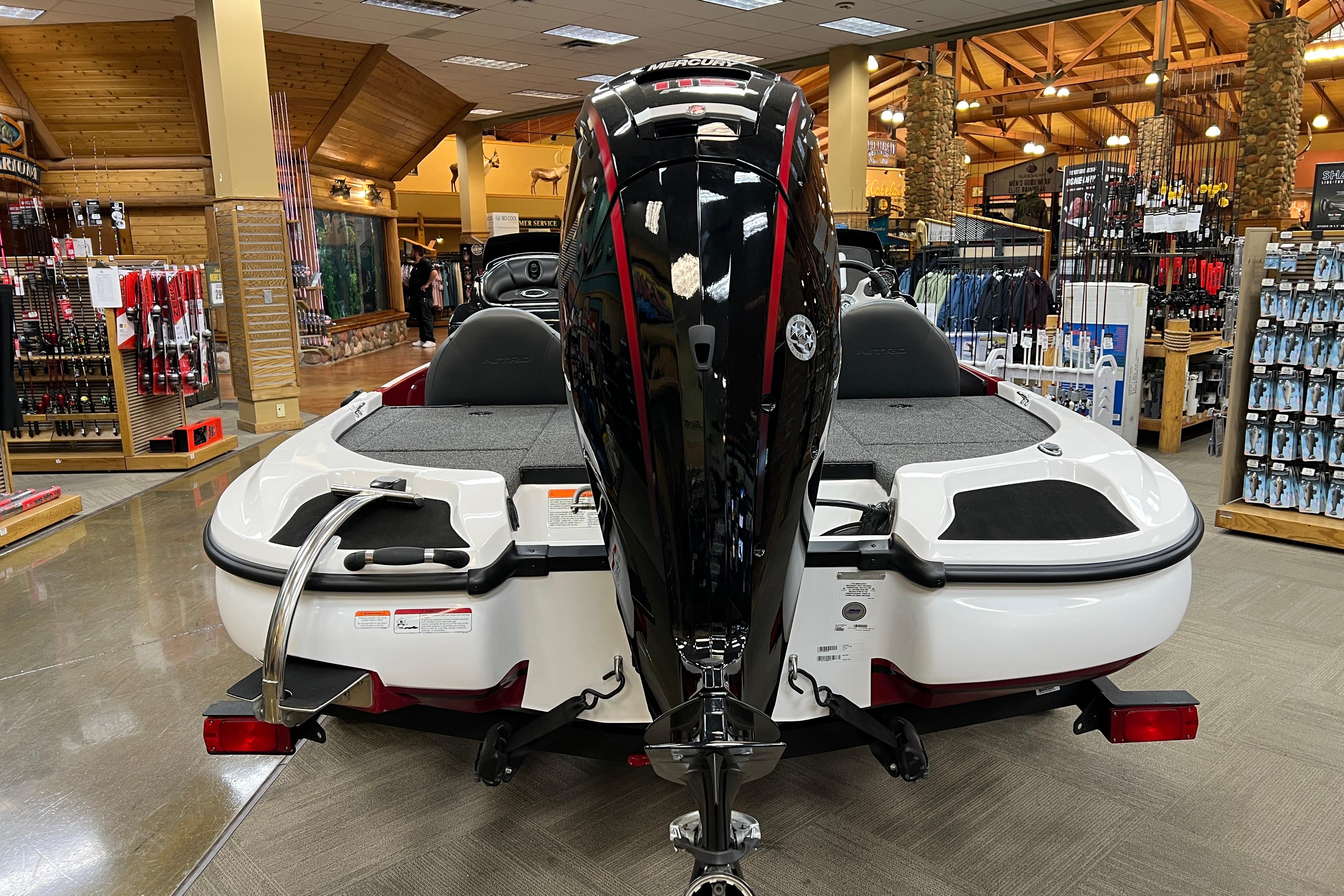2026 Nitro Z17 boat displayed indoors, featuring a sleek black motor and spacious seating.