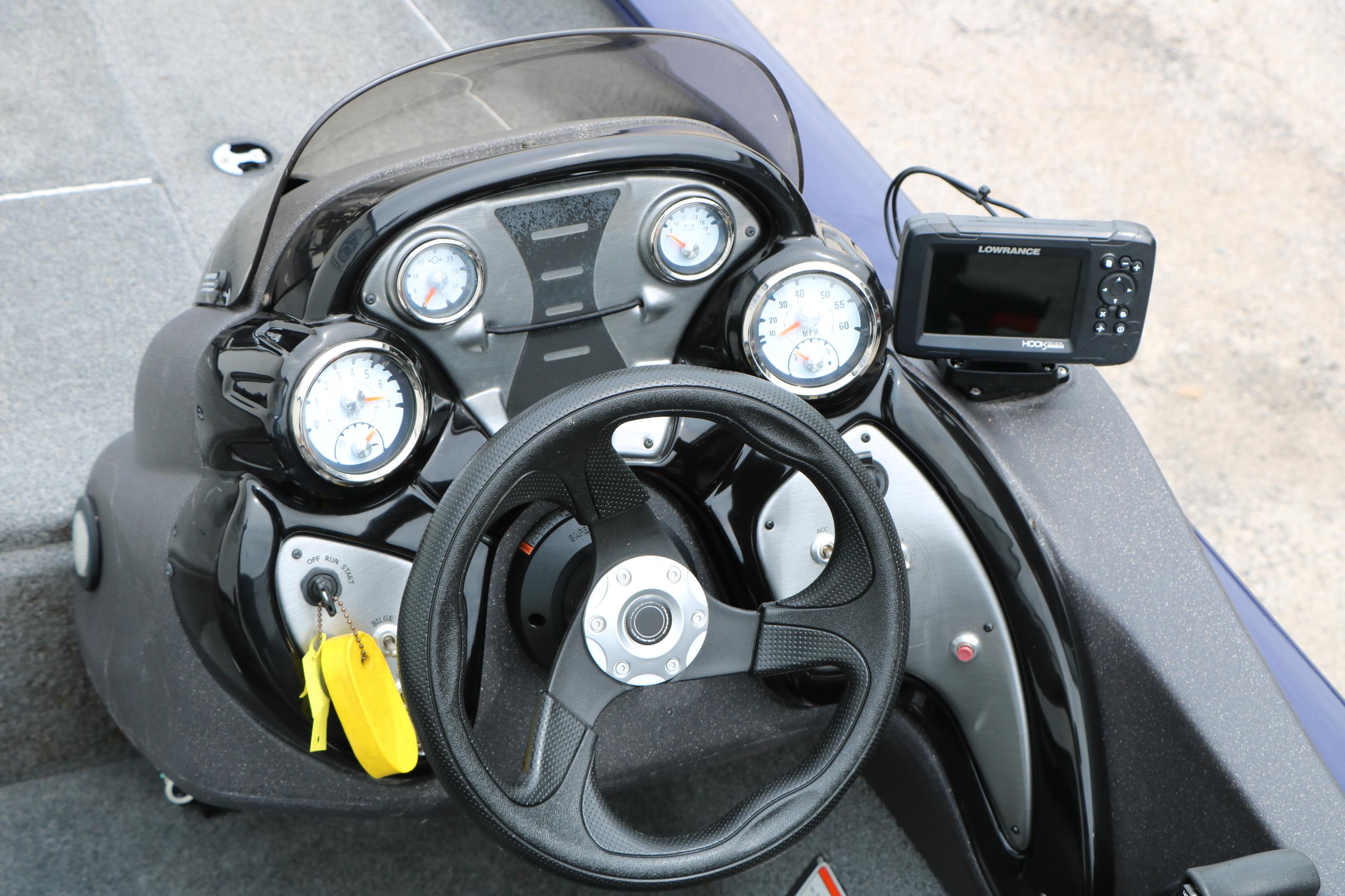 2022 Tracker Pro Team 175 TF boat dashboard with steering wheel and Lowrance fishfinder.