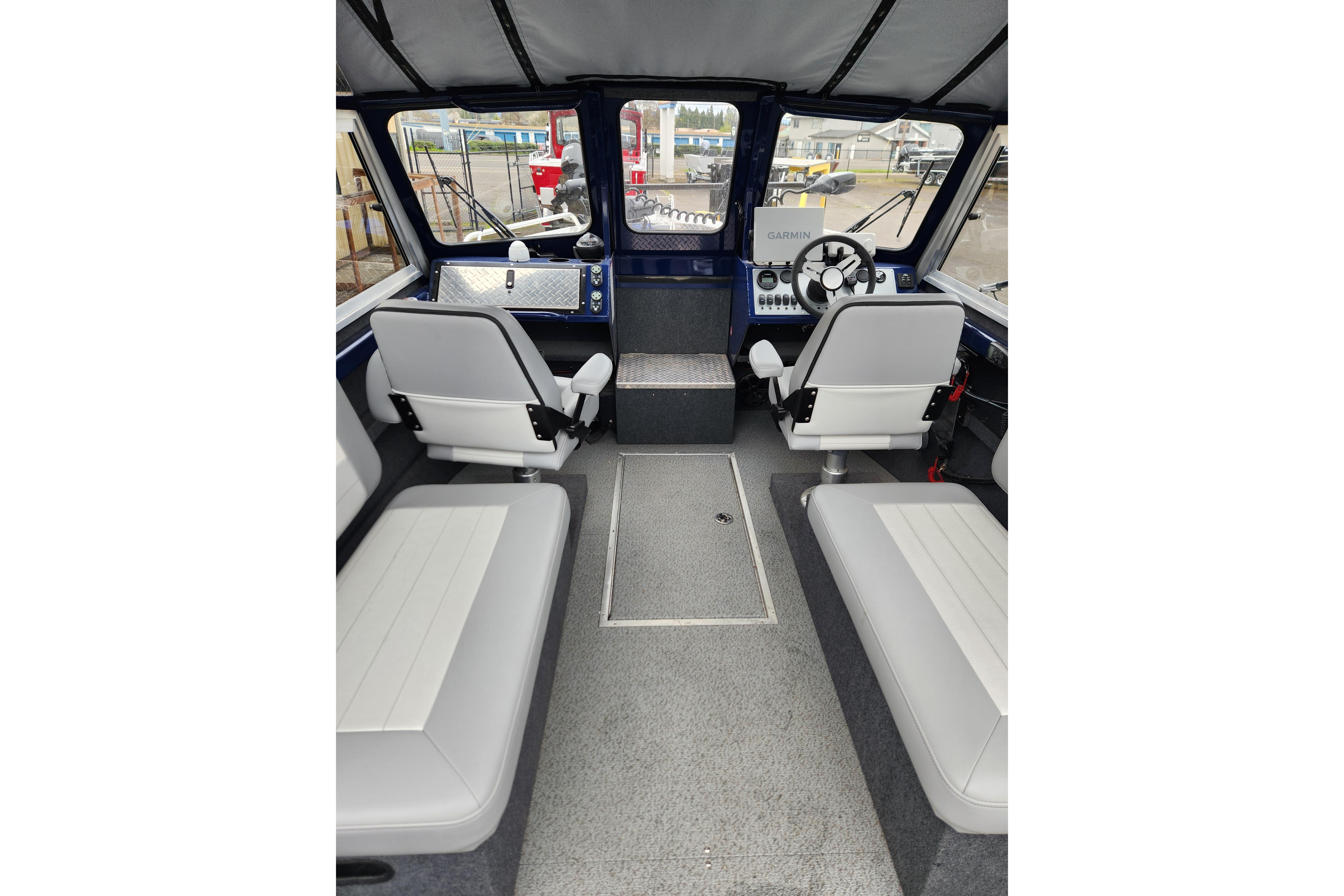 Interior of 2025 Thunder Jet 21 Chinook OS boat with seating and control panel.