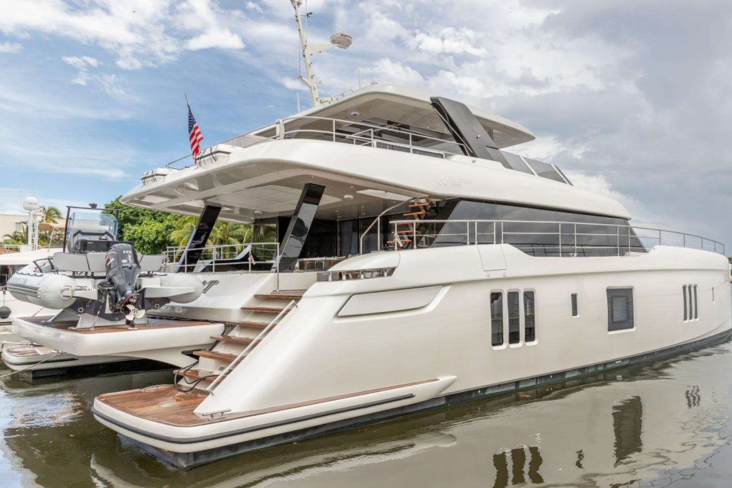 2024 Sunreef 80 Power yacht docked, showcasing luxury design and spacious decks.