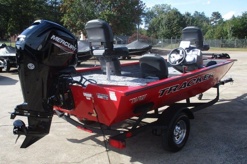 2026 Tracker Pro Team 175 boat with Mercury engine, red exterior, parked outdoors.