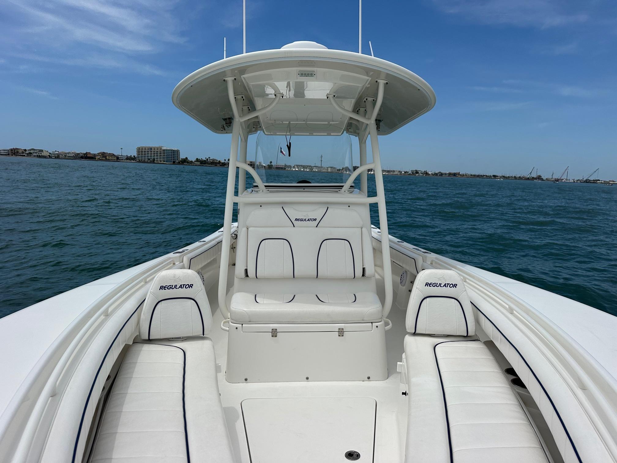 2016 Regulator center console boat on open water, clear sky, coastal background.