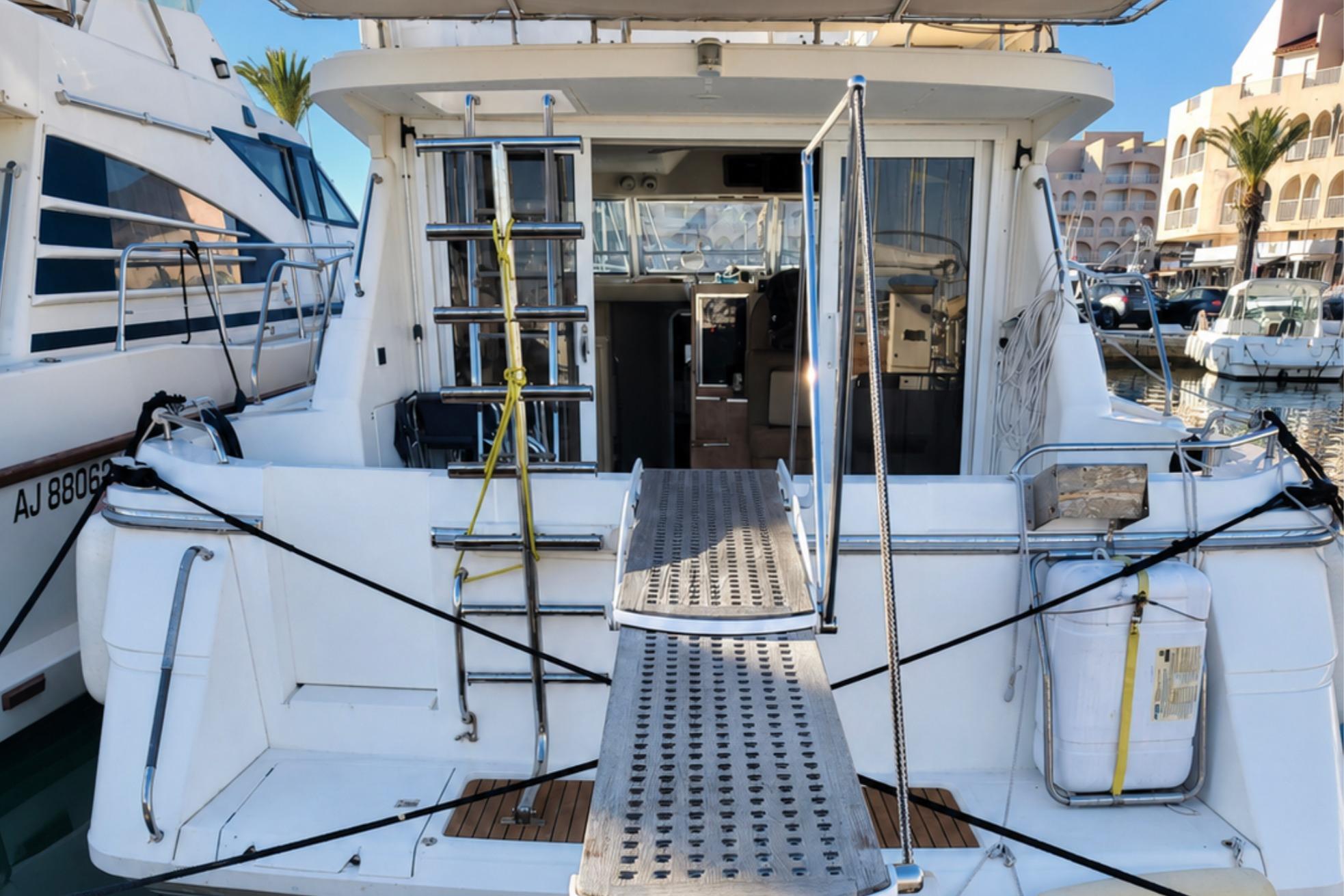 1993 Princess 410 yacht docked at marina, featuring rear deck and boarding ladder.
