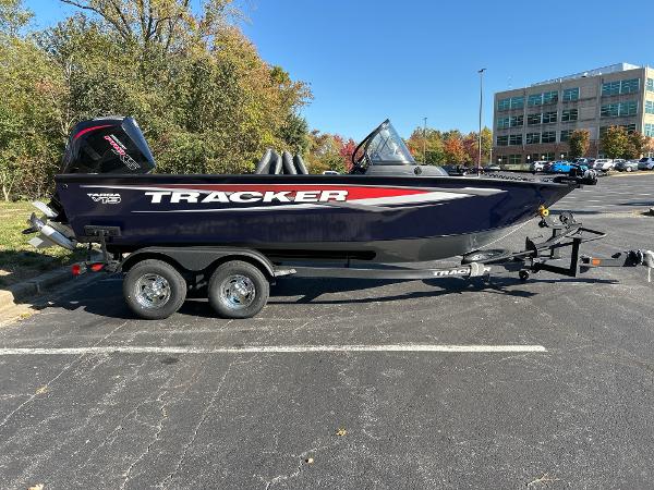 2025 Tracker Targa V-19 WT boat on trailer in parking lot, sunny day.