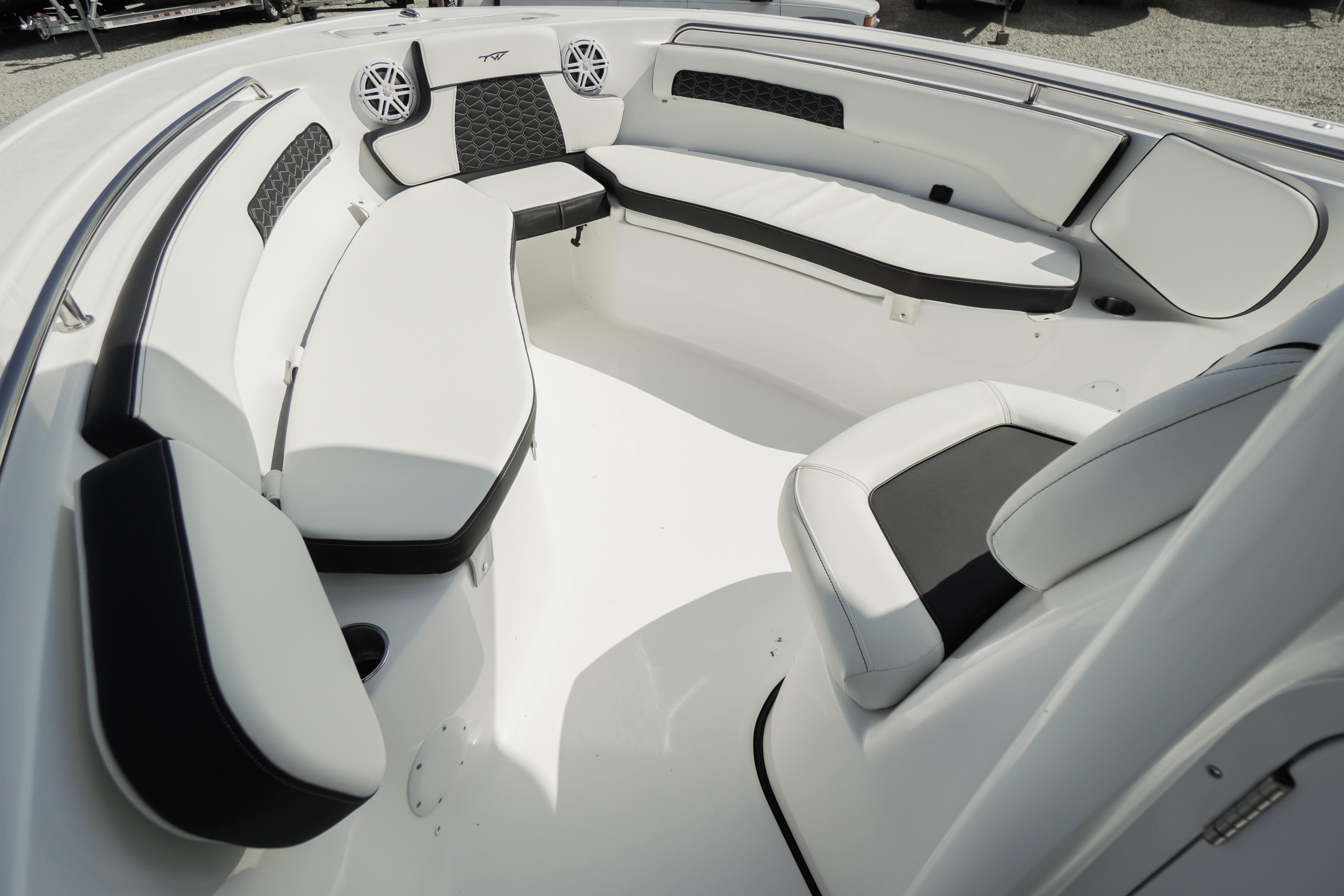 Interior seating of 2026 Tidewater 220 CC Adventure boat, featuring sleek white and black upholstery.