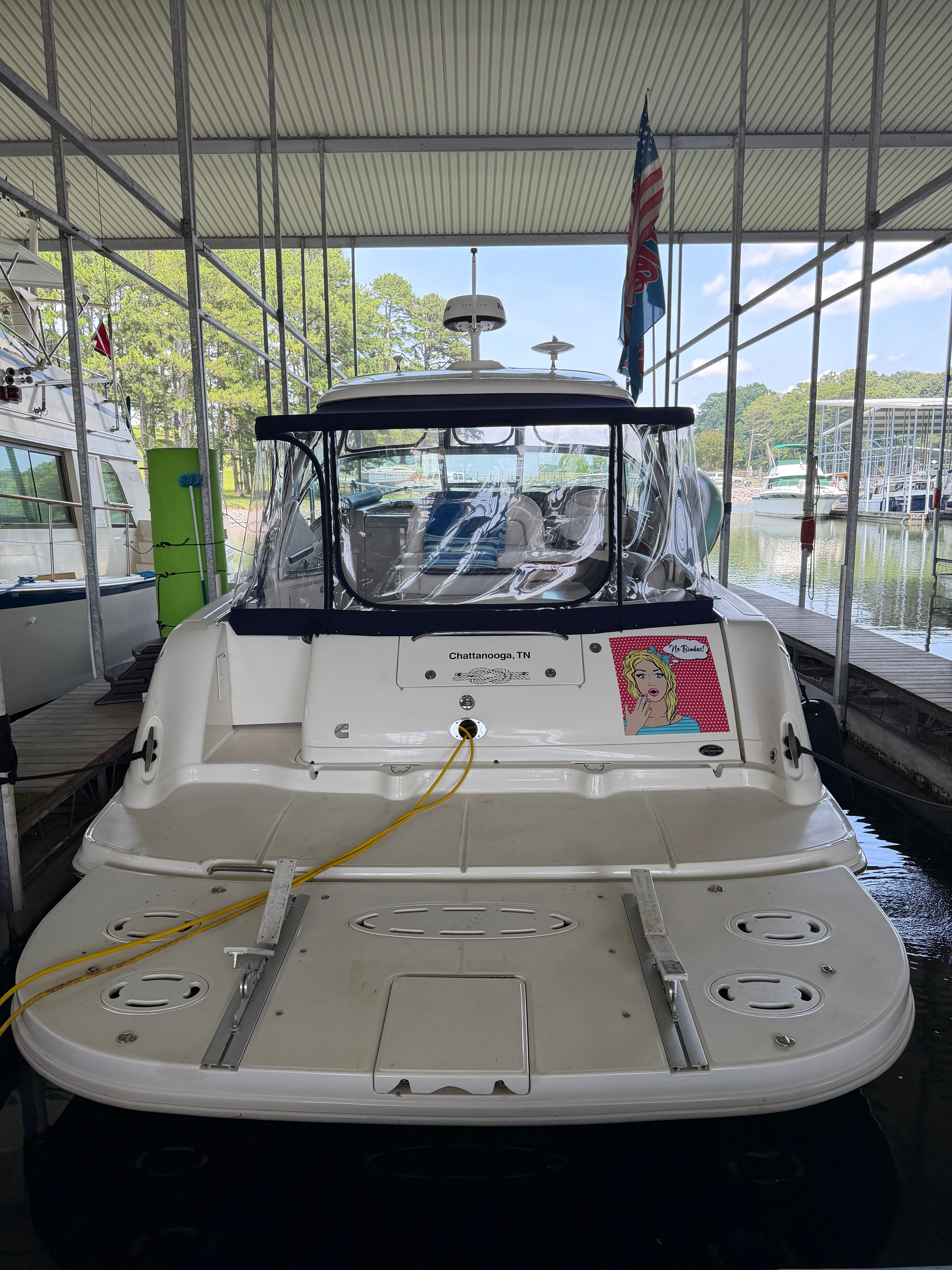 Rear view of a 2005 Sea Ray 420DA in a covered dock.