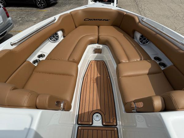2025 Crownline 290 SS boat interior with tan leather seating and wood accents.