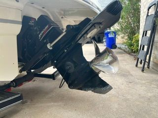 Close-up of a boat propeller and drive system on a trailer.