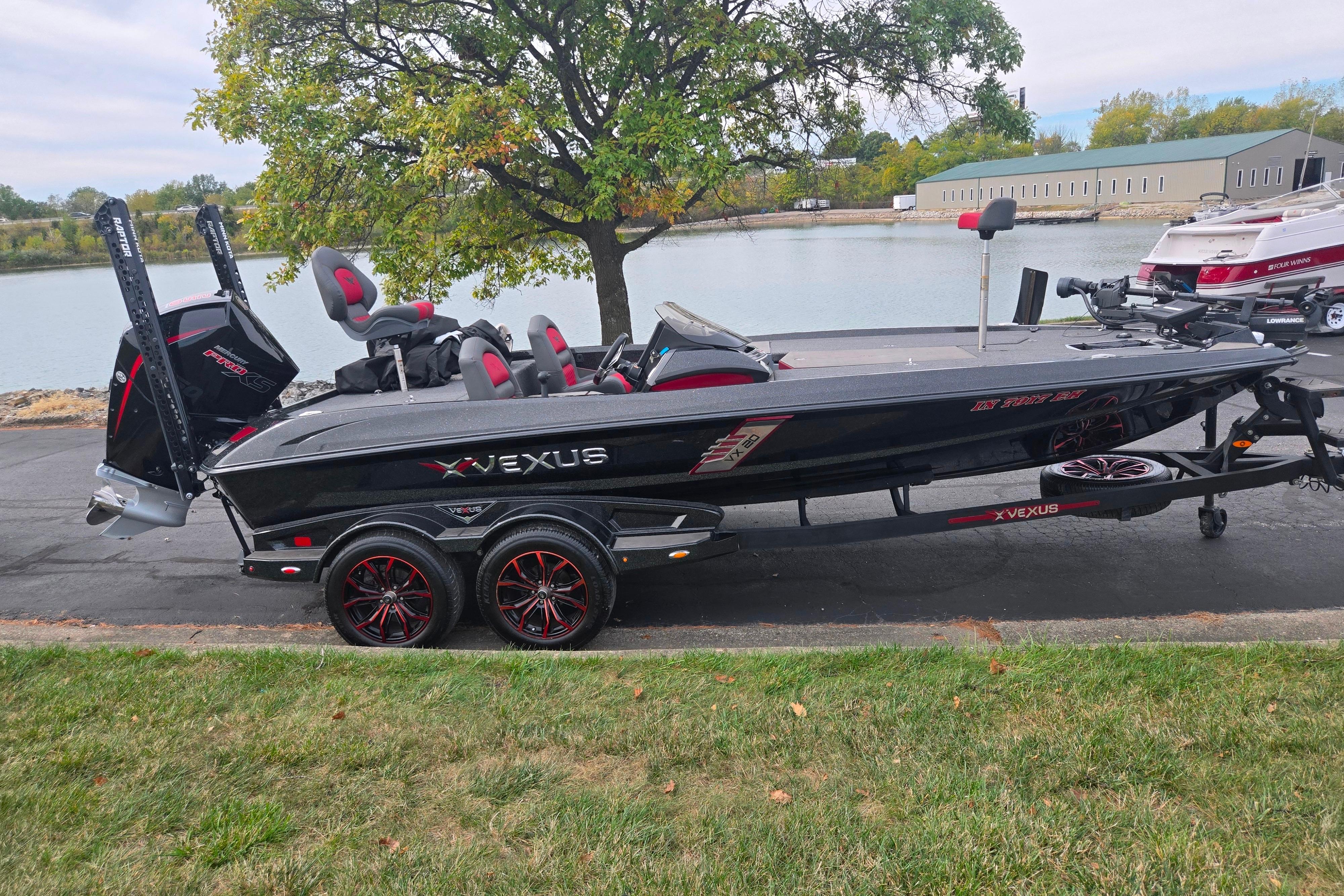 2022 Vexus VX20 boat on trailer by a lake, featuring sleek design and modern features.