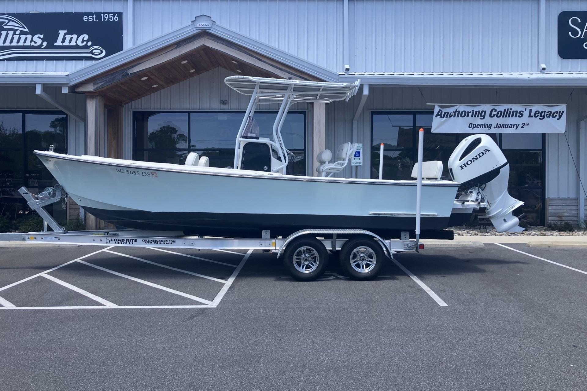 2022 May-Craft 2300 CCX boat on trailer outside dealership.