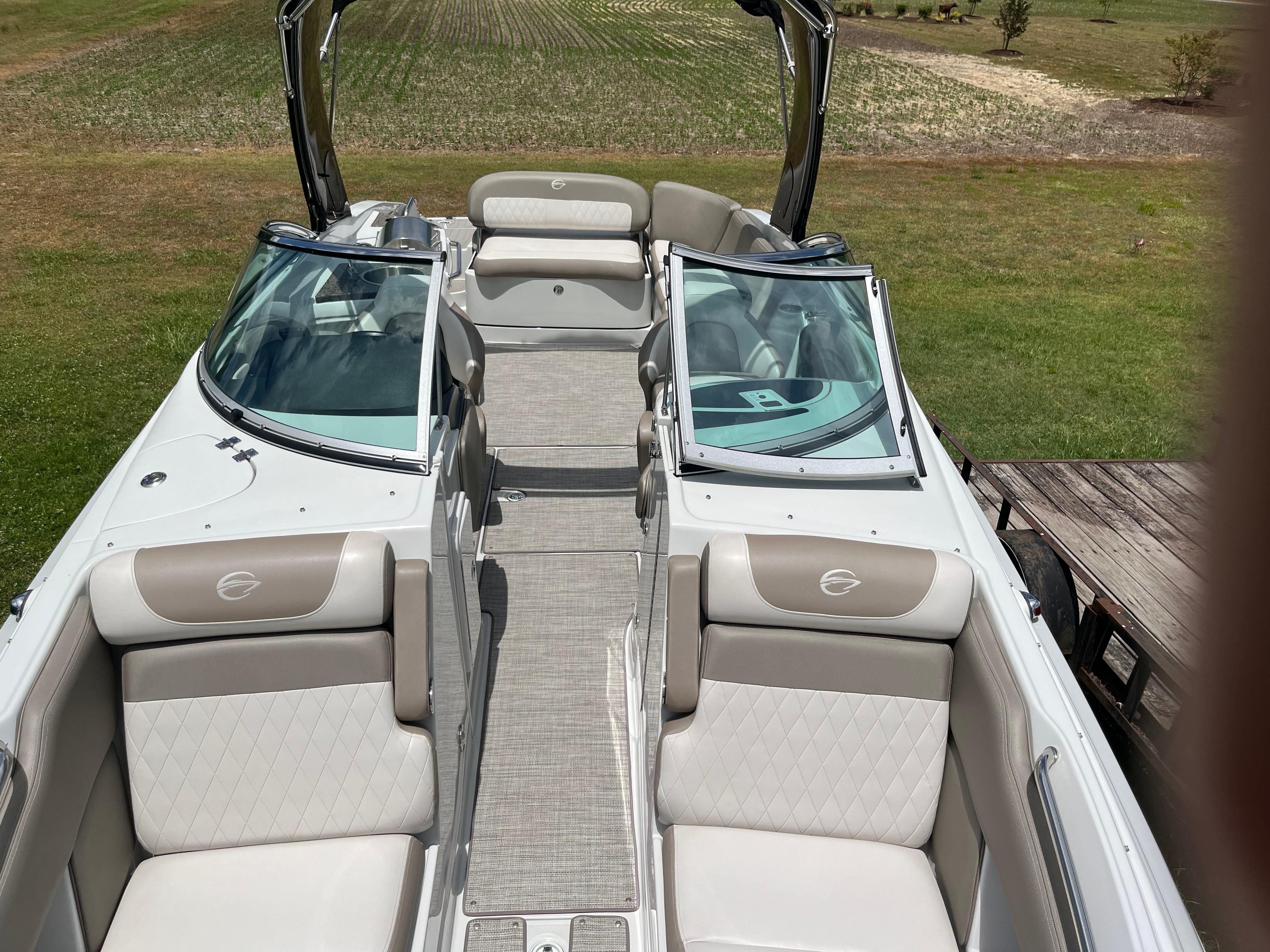 The image shows the interior of a 2019 Crownline E 285 boat with elegant seating.