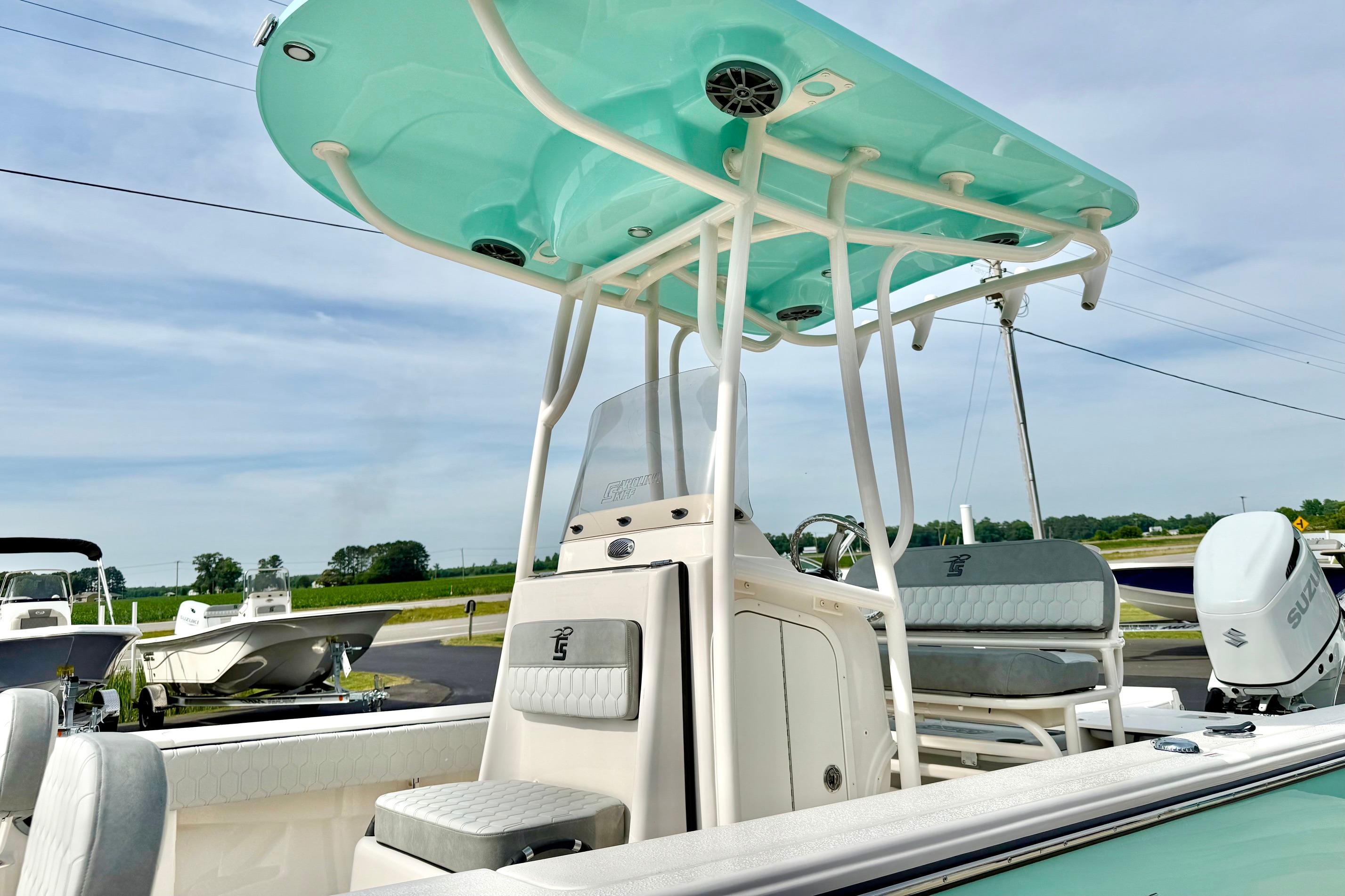 2026 Carolina Skiff 24 Ultra Elite boat with T-top and Suzuki outboard motor.