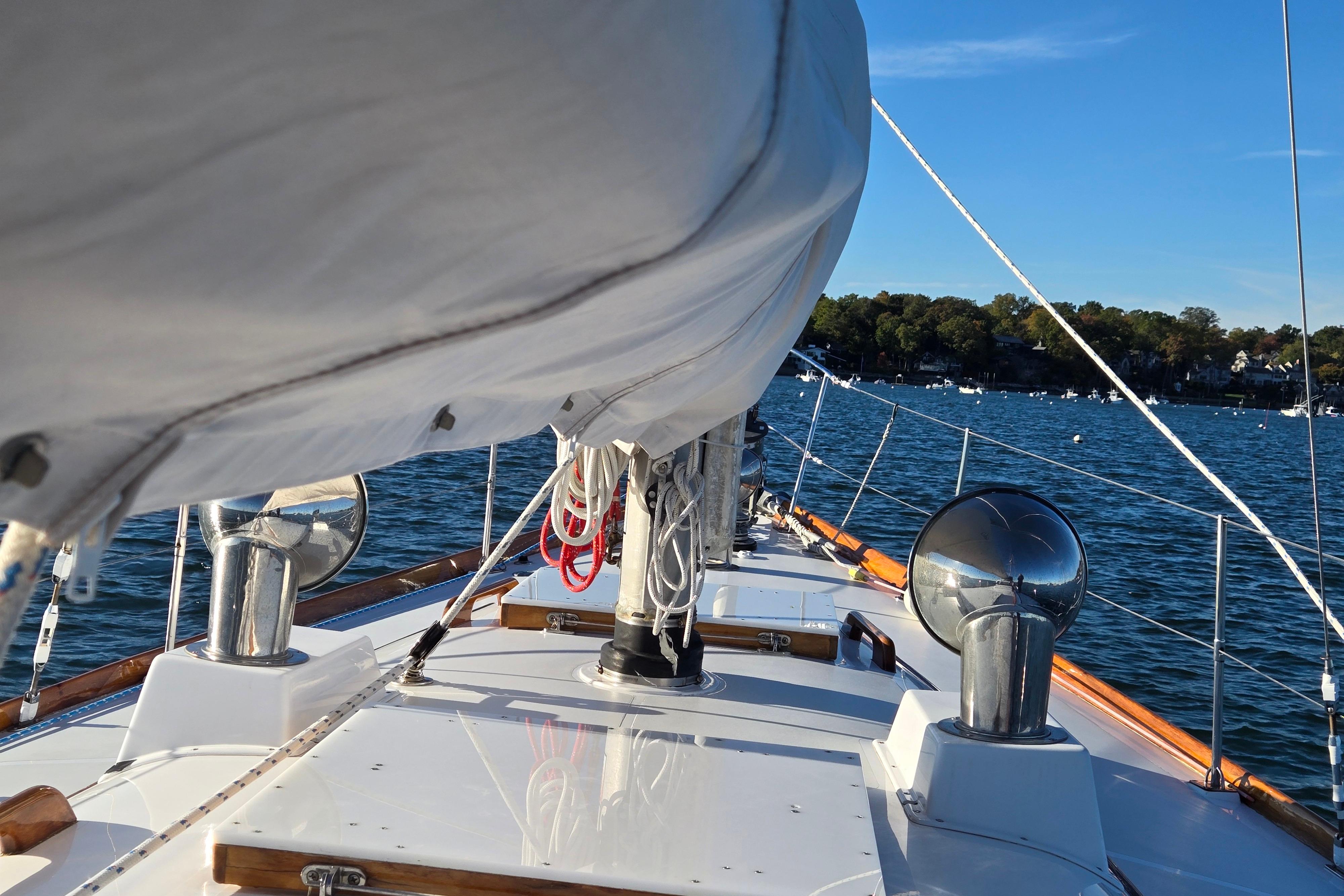1970 Hinckley Bermuda 40 sailboat deck view on a sunny day at sea.
